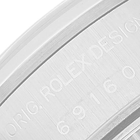 This close-up angle shows the engraved text on the bezel of a Rolex Date 69160 Women
s Stainless Steel White Dial 69160 Women
s Stainless Steel White Dial model watch.