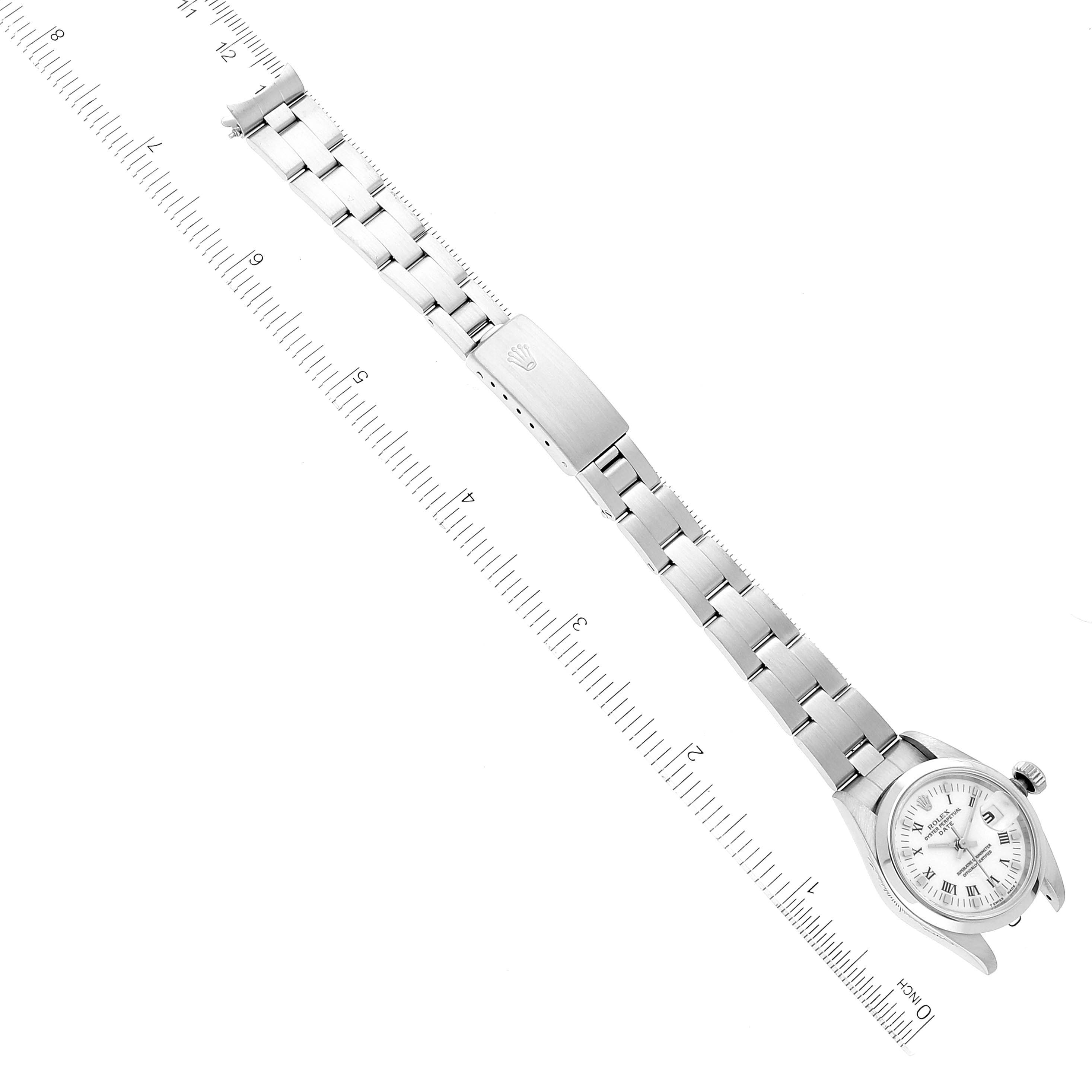 The image shows a Rolex Date 69160 Women
s Stainless Steel White Dial 69160 Women
s Stainless Steel White Dial watch laid flat with the bracelet fully extended, measured against a ruler.