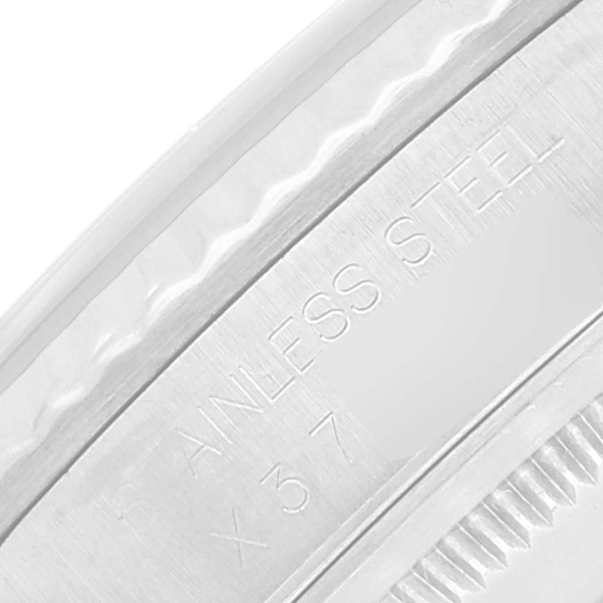 The image shows a close-up of the stainless steel part of a Rolex Datejust 16234 Men's Stainless Steel Silver Dial 16234 Men's Stainless Steel Silver Dial watch, featuring engravings.