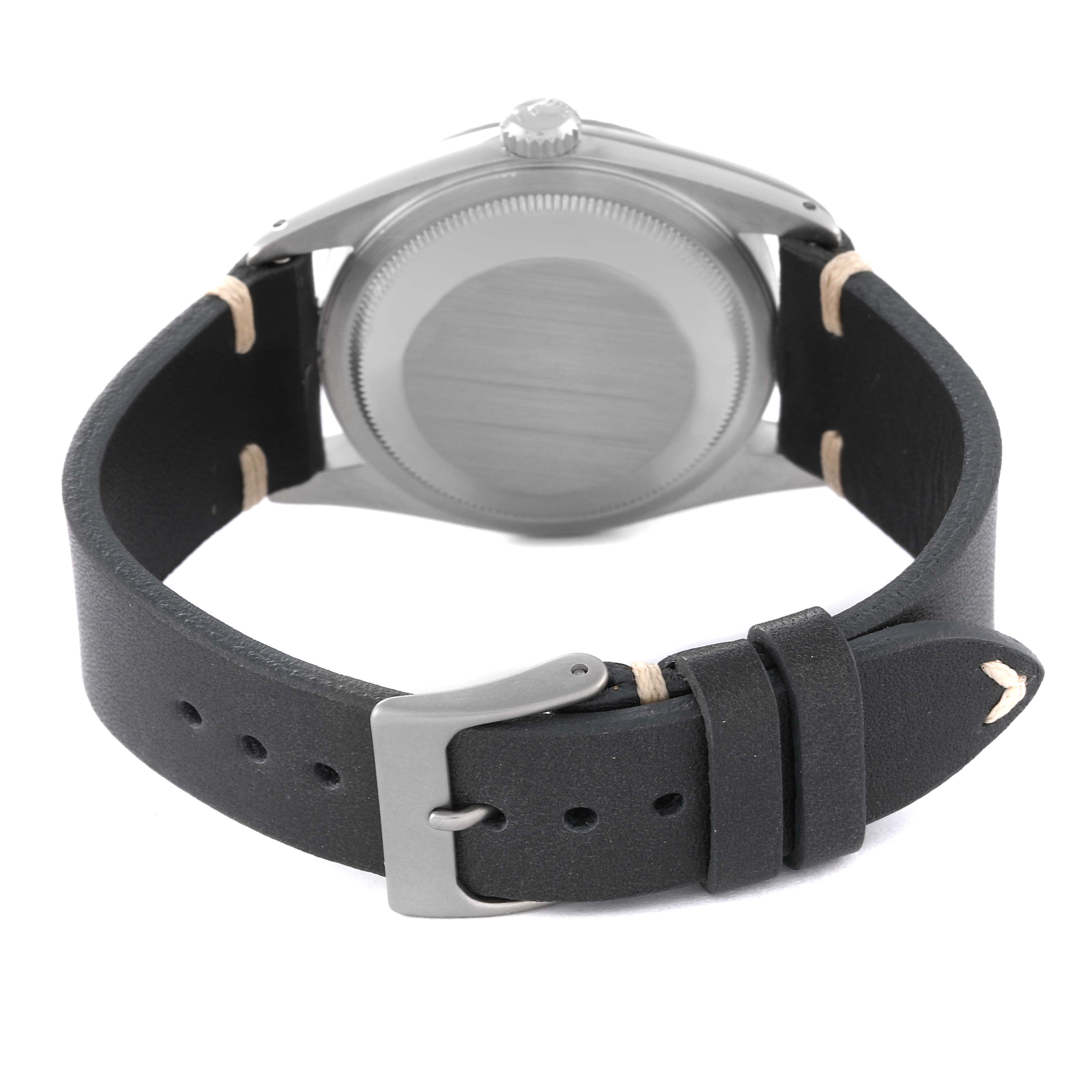 This image shows the back view of a Rolex Datejust 16234 Men's Stainless Steel Silver Dial 16234 Men's Stainless Steel Silver Dial watch case and its black leather strap with a buckle.