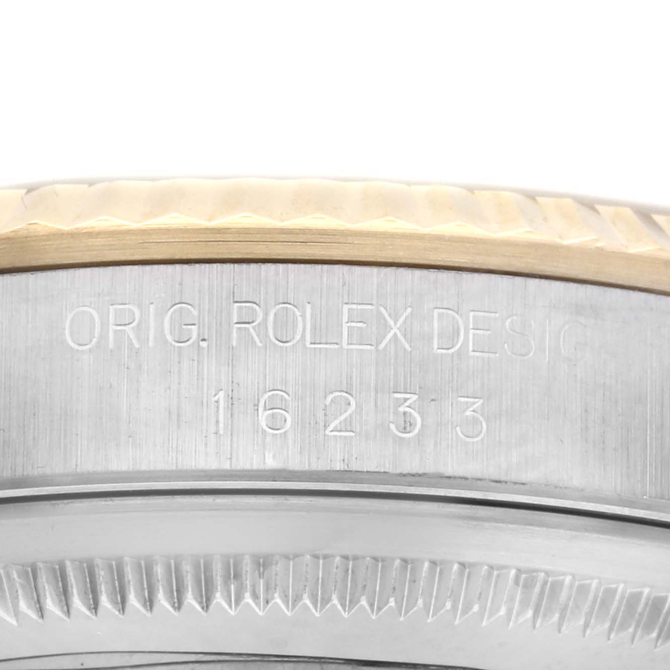 The image shows a close-up of the side of a Rolex Datejust 16233 Men's Steel and Gold (two tone) Champagne Dial 16233 Men's Steel and Gold (two tone) Champagne Dial watch, focusing on the bezel and model engraving.