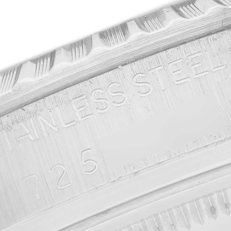 The image shows an angled close-up of the stainless steel bezel and engraving of a Rolex Datejust 16030 Men's Stainless Steel Silver Dial 16030 Men's Stainless Steel Silver Dial watch.