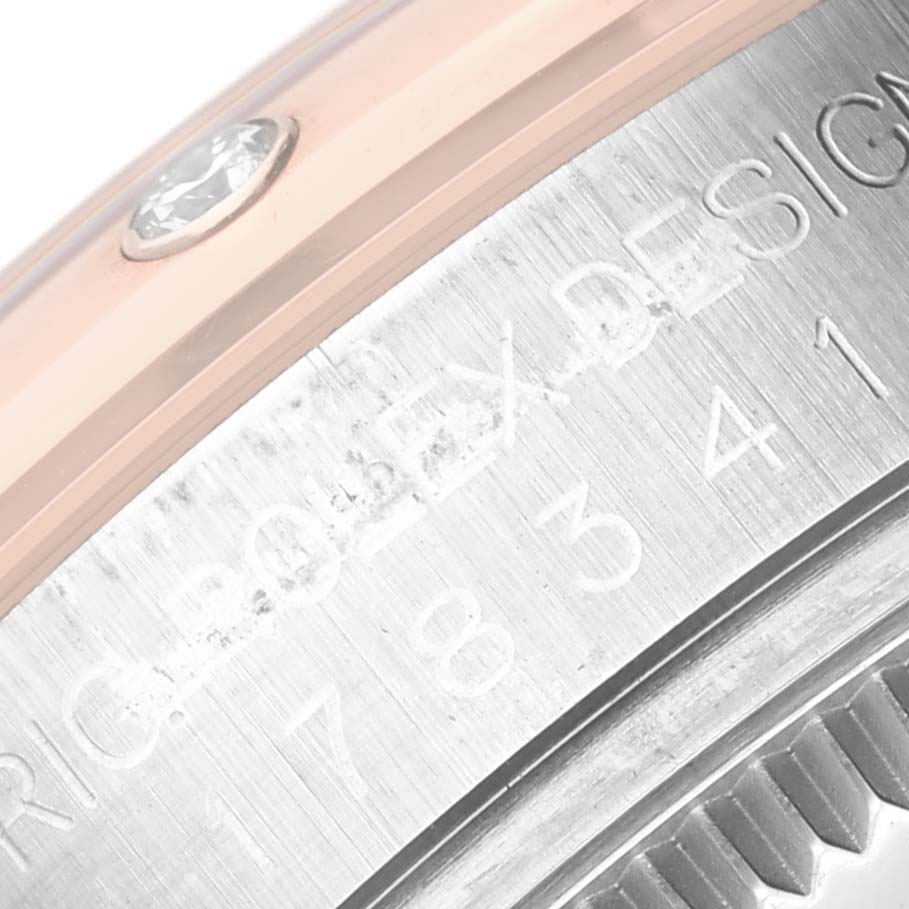 This image shows a close-up of the side and back of a Rolex Mid-Size 178341 Women's Steel and Gold (two tone) Brown Dial 178341 Women's Steel and Gold (two tone) Brown Dial model watch, highlighting the engraving and part of the bezel.