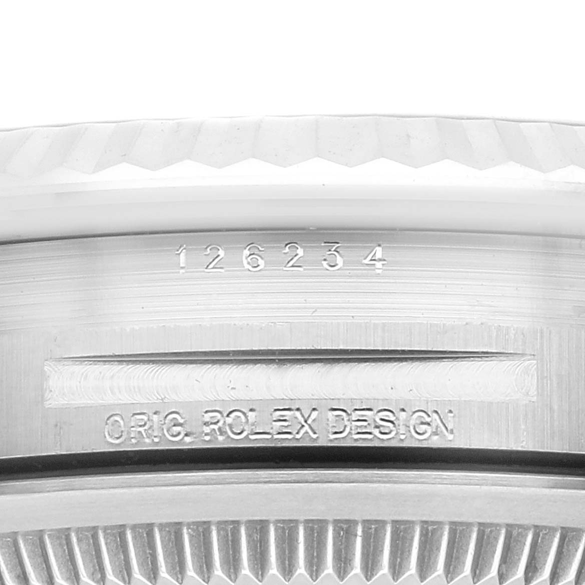 This zoomed-in shot of the Rolex Datejust 126234 Men's Stainless Steel Green Dial 126234 Men's Stainless Steel Green Dial model shows the engraved model number and "ORIG ROLEX DESIGN" on the watch case.