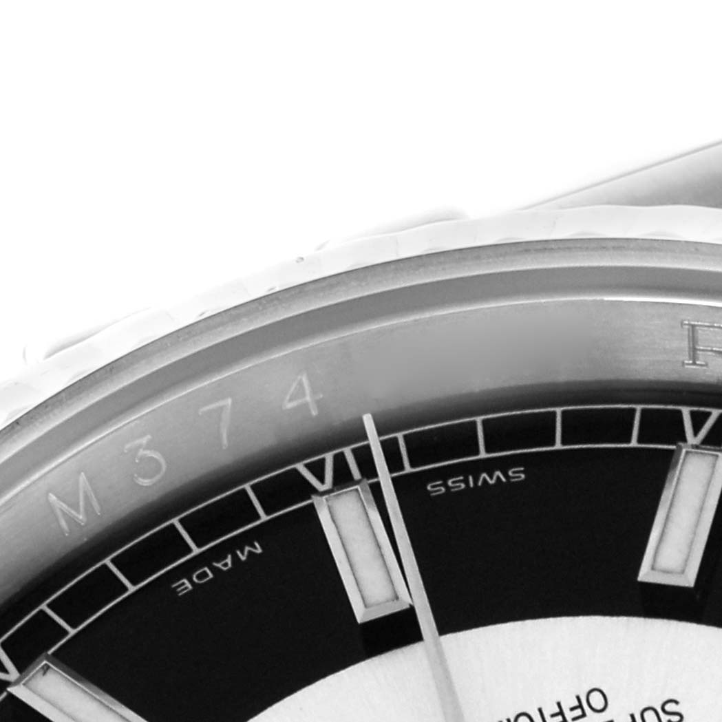 The image shows a close-up of the bezel and part of the dial of a Rolex Datejust 116234 Men's Stainless Steel Black Dial 116234 Men's Stainless Steel Black Dial, focusing on the markers and part of the chapter ring.