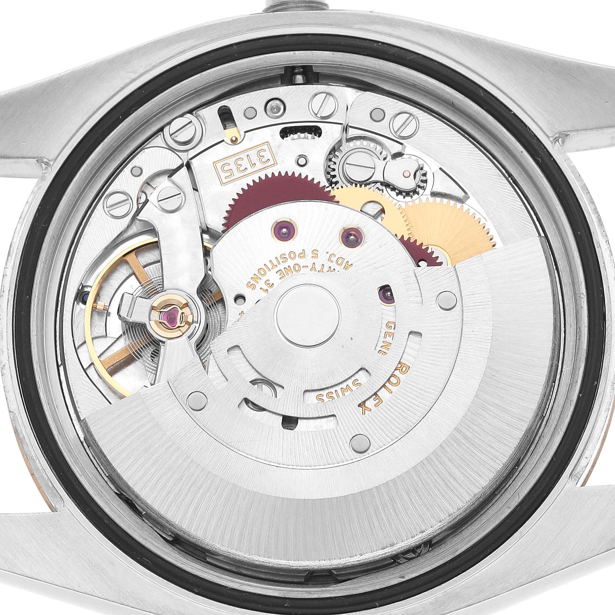 The image shows the movement mechanism of a Rolex Datejust 116233 Men's Steel and Gold (two tone) Silver Dial watch from a back angle, highlighting gears and springs.