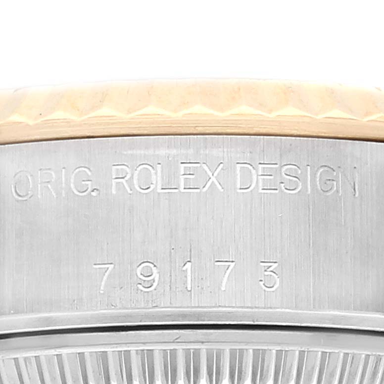 The image shows a detailed close-up of the side of the Rolex Datejust 79173 Women's Steel and Gold (two tone) Champagne Dial 79173 Women's Steel and Gold (two tone) Champagne Dial watch, displaying the engraved model number and "ORIG. ROLEX DESIGN."