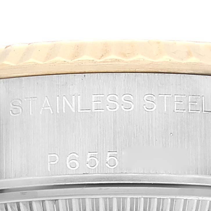 Close-up of the side of a Rolex Datejust 79173 Women's Steel and Gold (two tone) Champagne Dial 79173 Women's Steel and Gold (two tone) Champagne Dial, showing stainless steel engraving and partial view of the bezel.