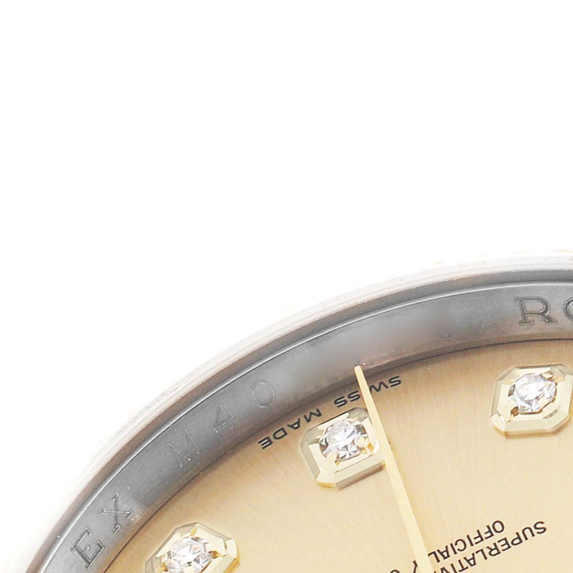 The image shows a close-up of the dial and diamond markers of a Rolex Datejust 116233 Men's Steel and Gold (two tone) Champagne Dial watch, focusing on part of the bezel.