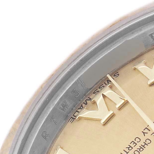 The image shows a close-up of the Rolex Datejust 179173 Women's Steel and Gold (two tone) Champagne Dial dial and bezel, focusing on indices and part of the chapter ring.