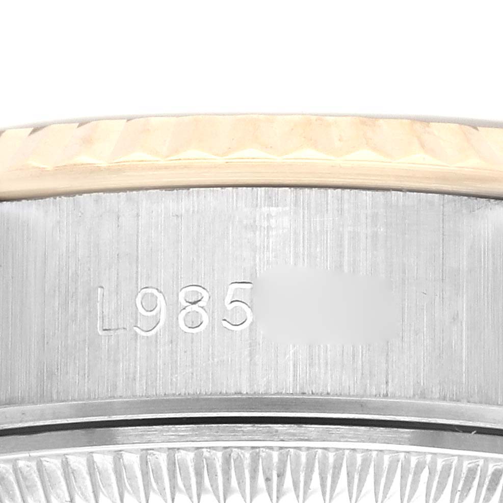 This close-up image of the Rolex Datejust 69173 Women's Steel and Gold (two tone) Champagne Dial 69173 Women's Steel and Gold (two tone) Champagne Dial shows the engraved side of the watch case and part of the bezel.