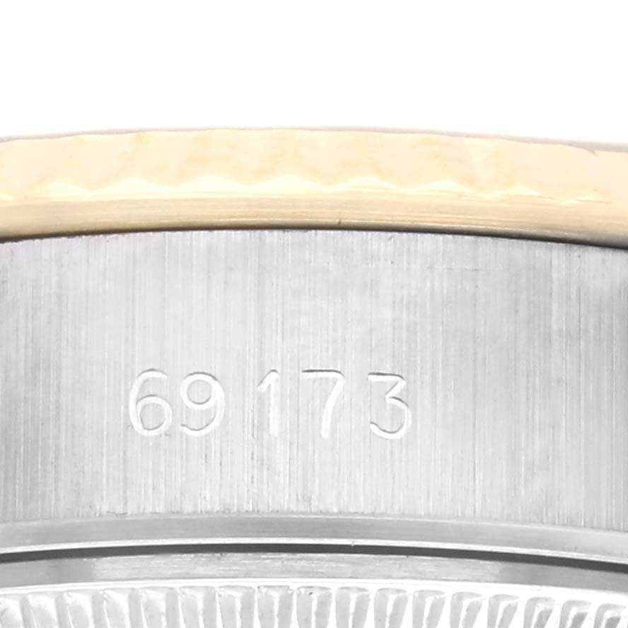 The image shows a close-up of the case side of a Rolex Datejust 69173 Women's Steel and Gold (two tone) Champagne Dial 69173 Women's Steel and Gold (two tone) Champagne Dial, highlighting the model number engraved on the metal surface.