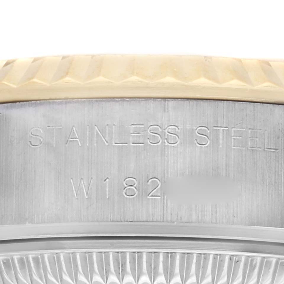 The image shows a close-up of the side of a Rolex Datejust 69173 Women's Steel and Gold (two tone) Champagne Dial 69173 Women's Steel and Gold (two tone) Champagne Dial watch, highlighting the stainless steel engraving and part of the bezel.