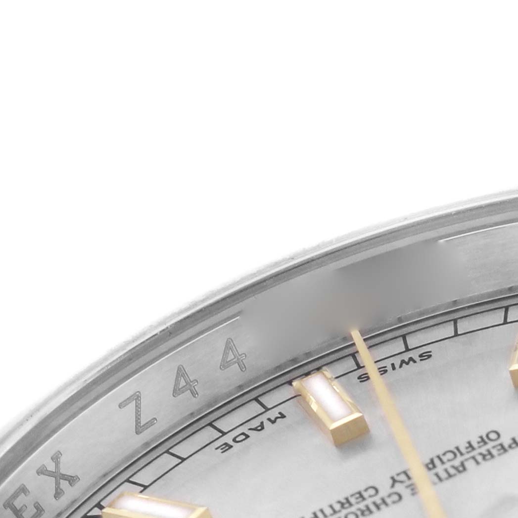 The image shows a close-up of the dial and rehaut of a Rolex Datejust 116233 Men's Stainless Steel Silver Dial, highlighting hour markers and part of the inscribed branding.