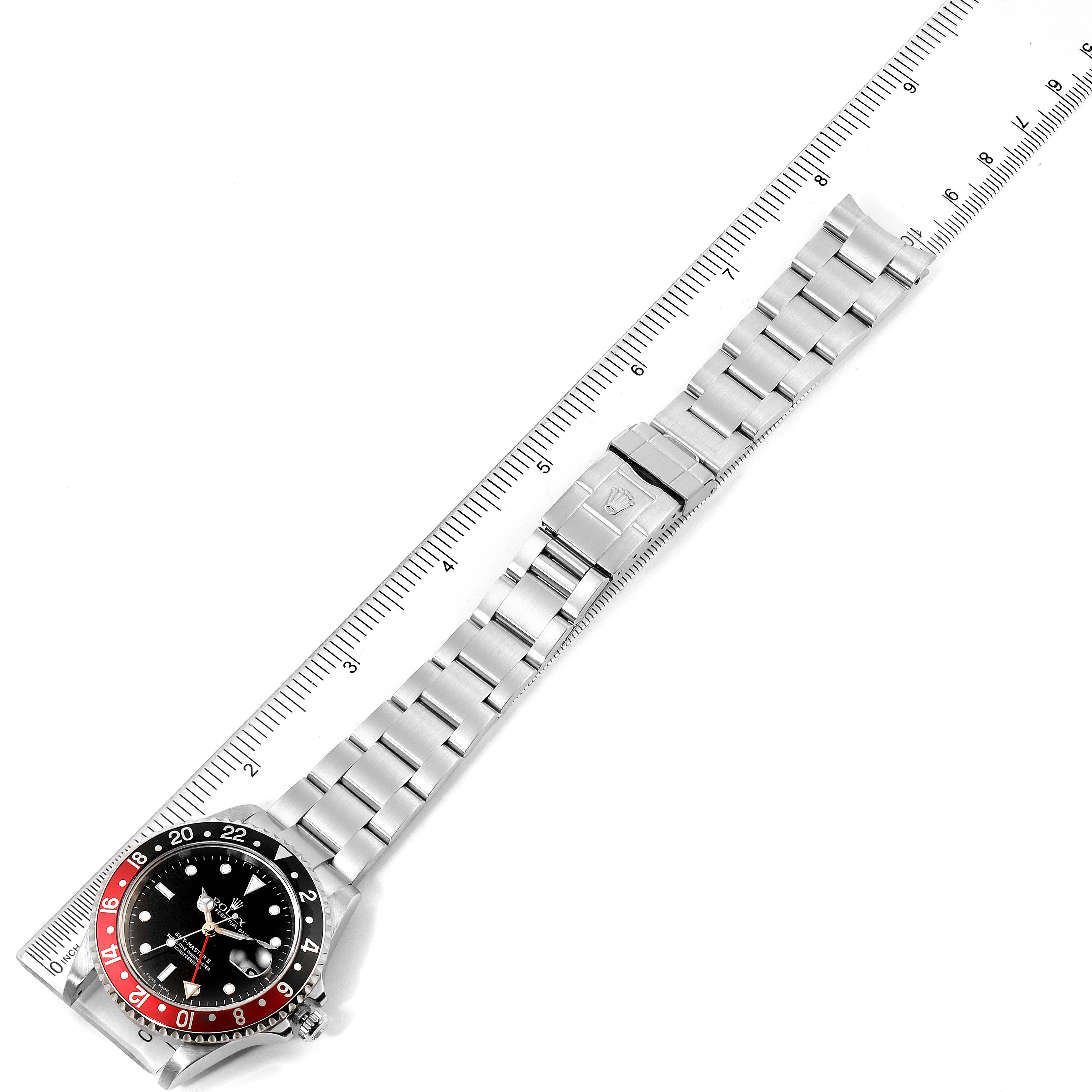 The image shows the Rolex GMT-Master 16710 Men's Stainless Steel Black Dial 16710 Men's Stainless Steel Black Dial watch laid flat with its bracelet fully extended alongside a ruler.
