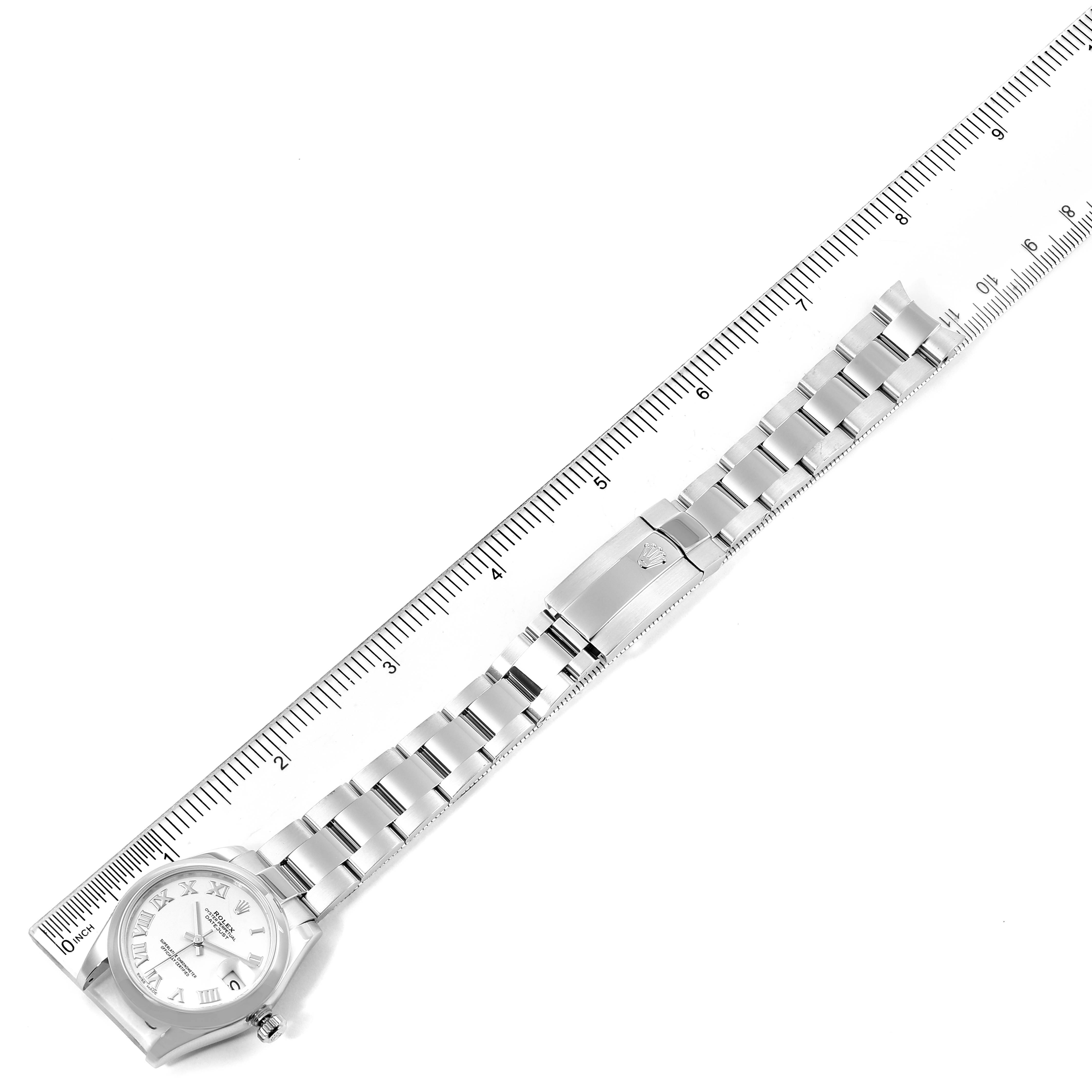 The image shows a Rolex Mid-Size 178240 Women
s Stainless Steel White Dial 178240 Women
s Stainless Steel White Dial model watch laid flat, with a ruler for scale.