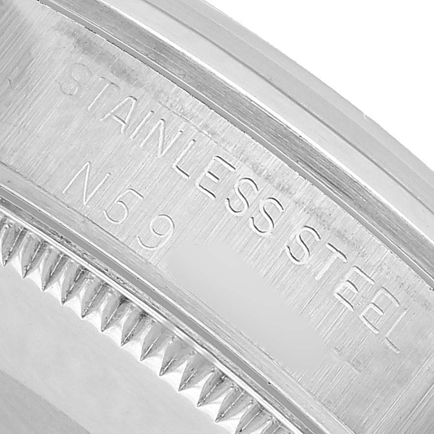 The image shows a close-up of the Rolex Oyster Perpetual 67480 Women's Stainless Steel Pink Dial case back, highlighting the engraved text and bezel edge.