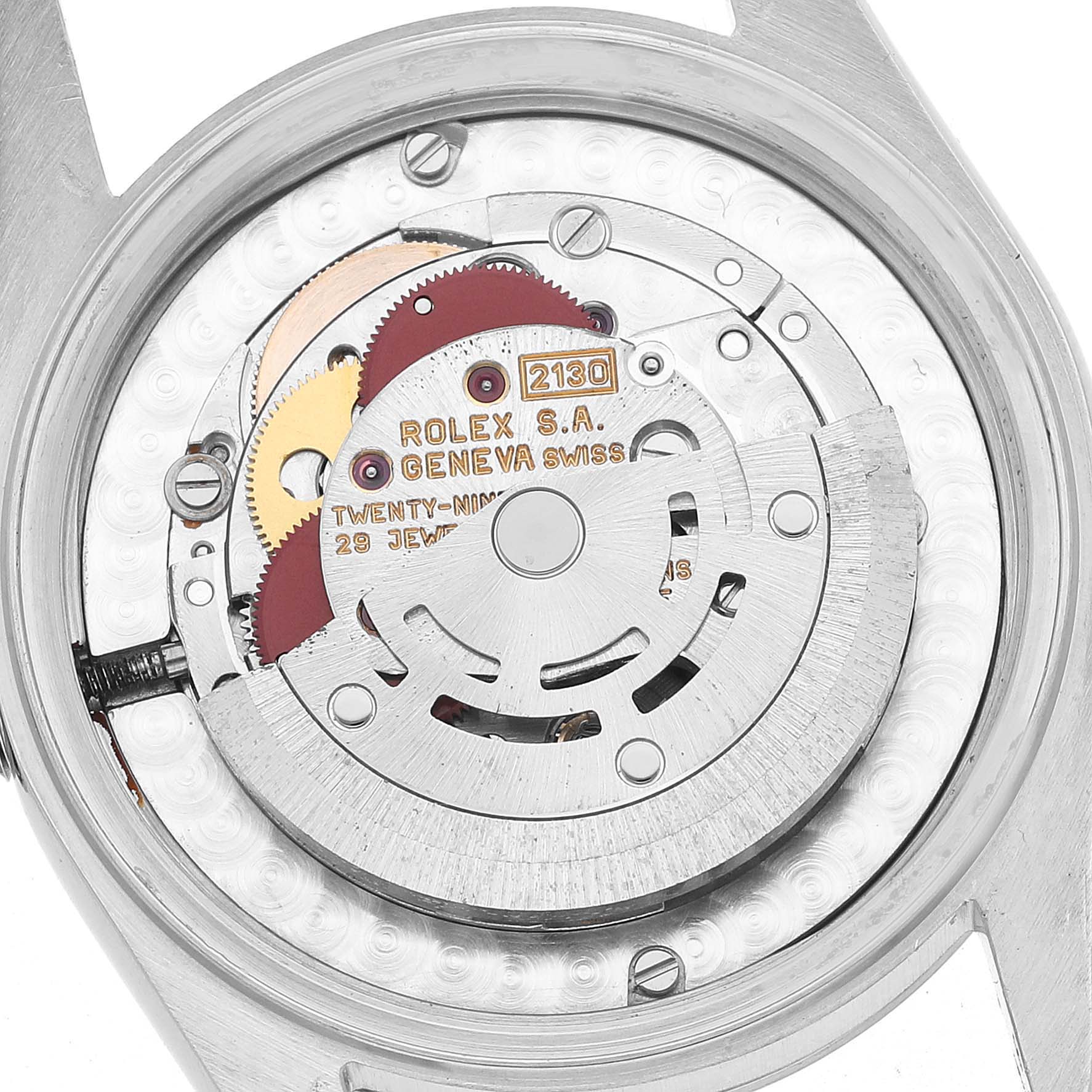 The image shows the movement of a Rolex Oyster Perpetual 67480 Women's Stainless Steel Pink Dial watch from a top-down angle, highlighting gears and engravings.