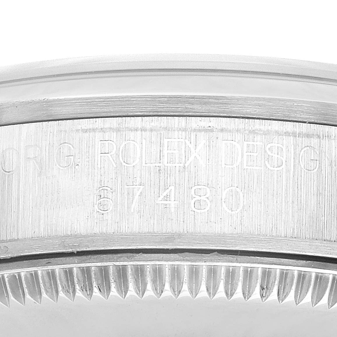 The image shows a close-up of the case side of a Rolex Mid-Size 67480 Women's Stainless Steel Black Dial 67480 Women's Stainless Steel Black Dial watch, highlighting the engraved model number.