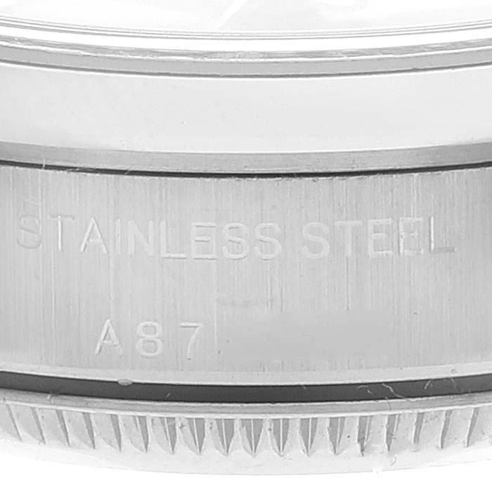 The image shows a close-up of the brushed stainless steel side and the partially visible bezel of a Rolex Oyster Perpetual 76080 Women's Stainless Steel Pink Dial 76080 Women's Stainless Steel Pink Dial watch.