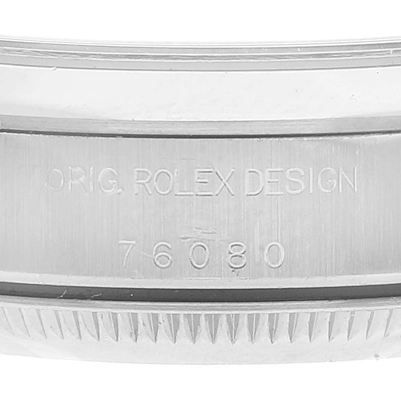 The image shows a close-up view of the engraving on the side of the case of a Rolex Oyster Perpetual 76080 Women's Stainless Steel Pink Dial 76080 Women's Stainless Steel Pink Dial watch.