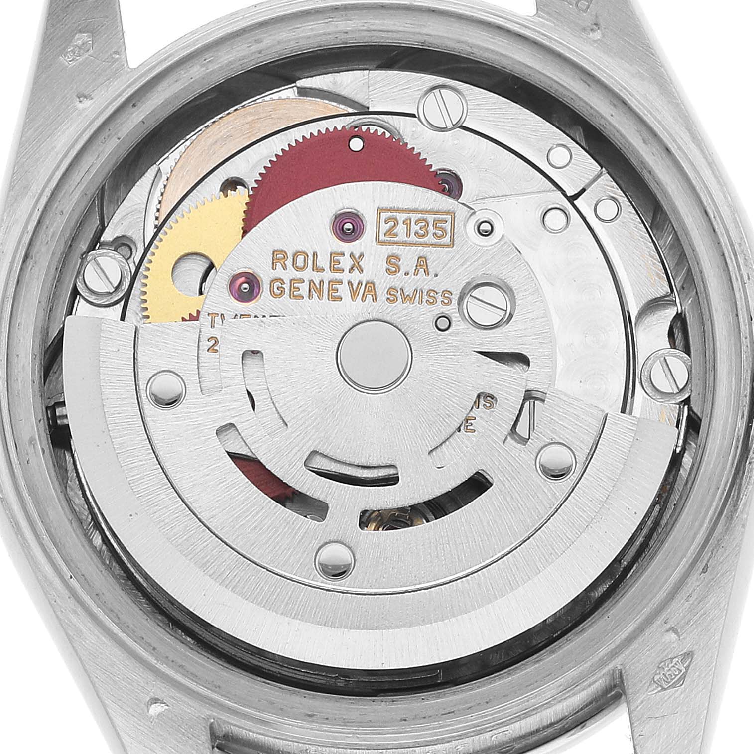 The image shows a close-up view of the movement inside a Rolex President 69136 Women's Platinum Silver Dial model, displaying gears and engravings.