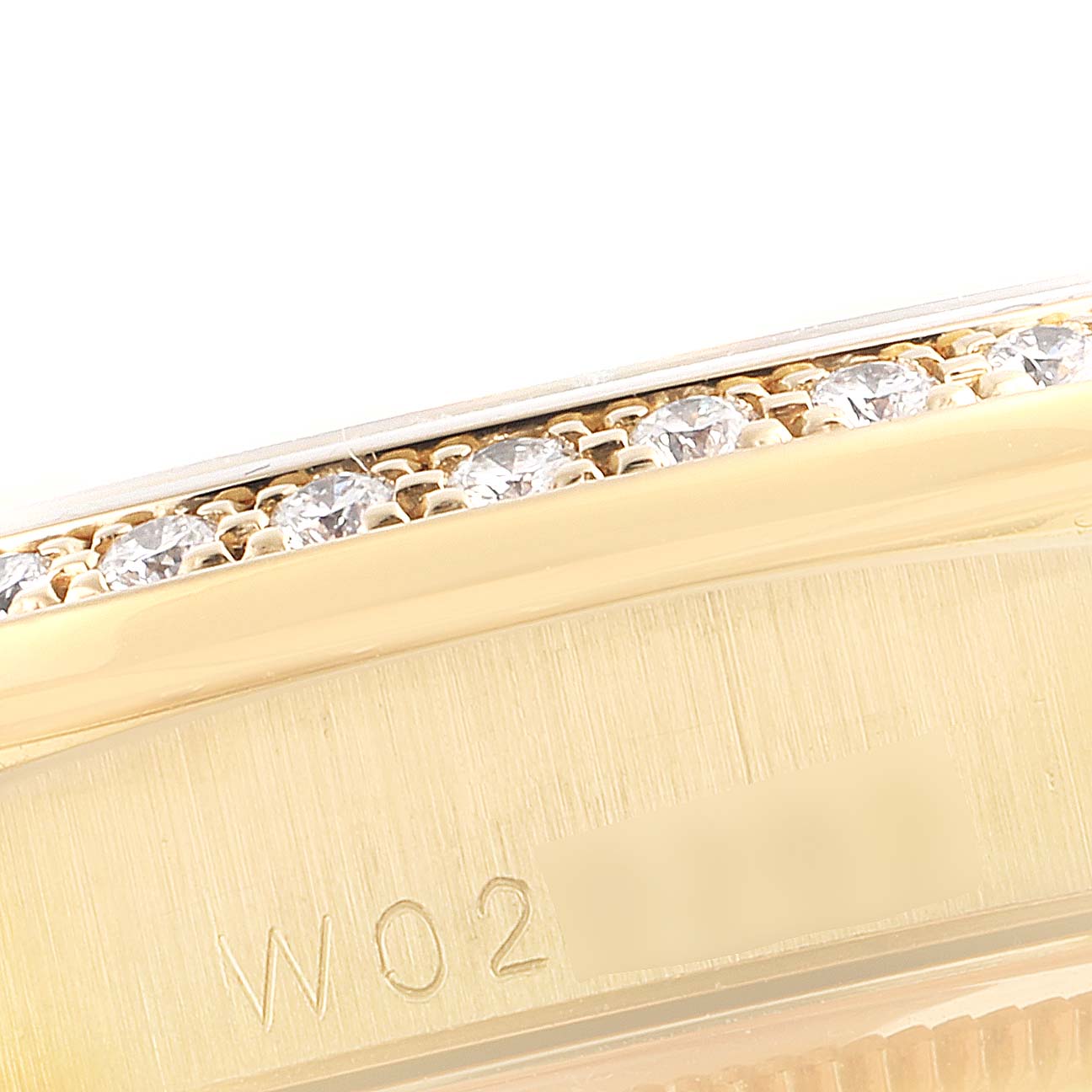 This close-up image shows the side profile of a Rolex President 18388 Men's Yellow Gold Brown Dial 18388 Men's Yellow Gold Brown Dial model, featuring a diamond-encrusted bezel and engraved markings.