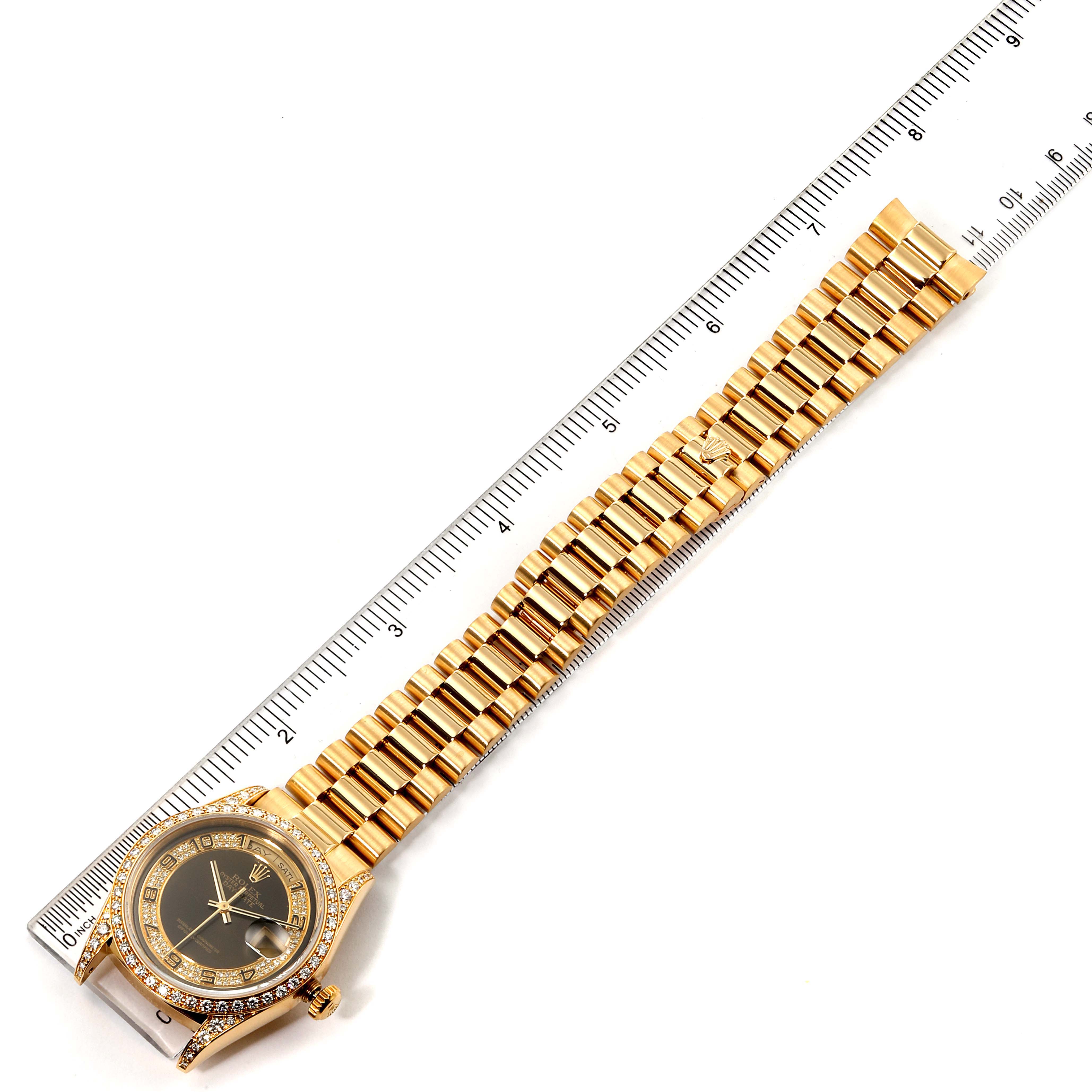The image shows a Rolex President 18388 Men's Yellow Gold Brown Dial 18388 Men's Yellow Gold Brown Dial model watch laid flat with its full bracelet next to a ruler for scale.