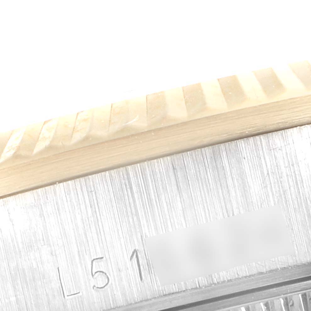 This image shows a close-up of the bezel and part of the case of a Rolex President 68279 Women's Yellow Gold Brown Dial 68279 Women's Yellow Gold Brown Dial model watch, with some visible engravings.