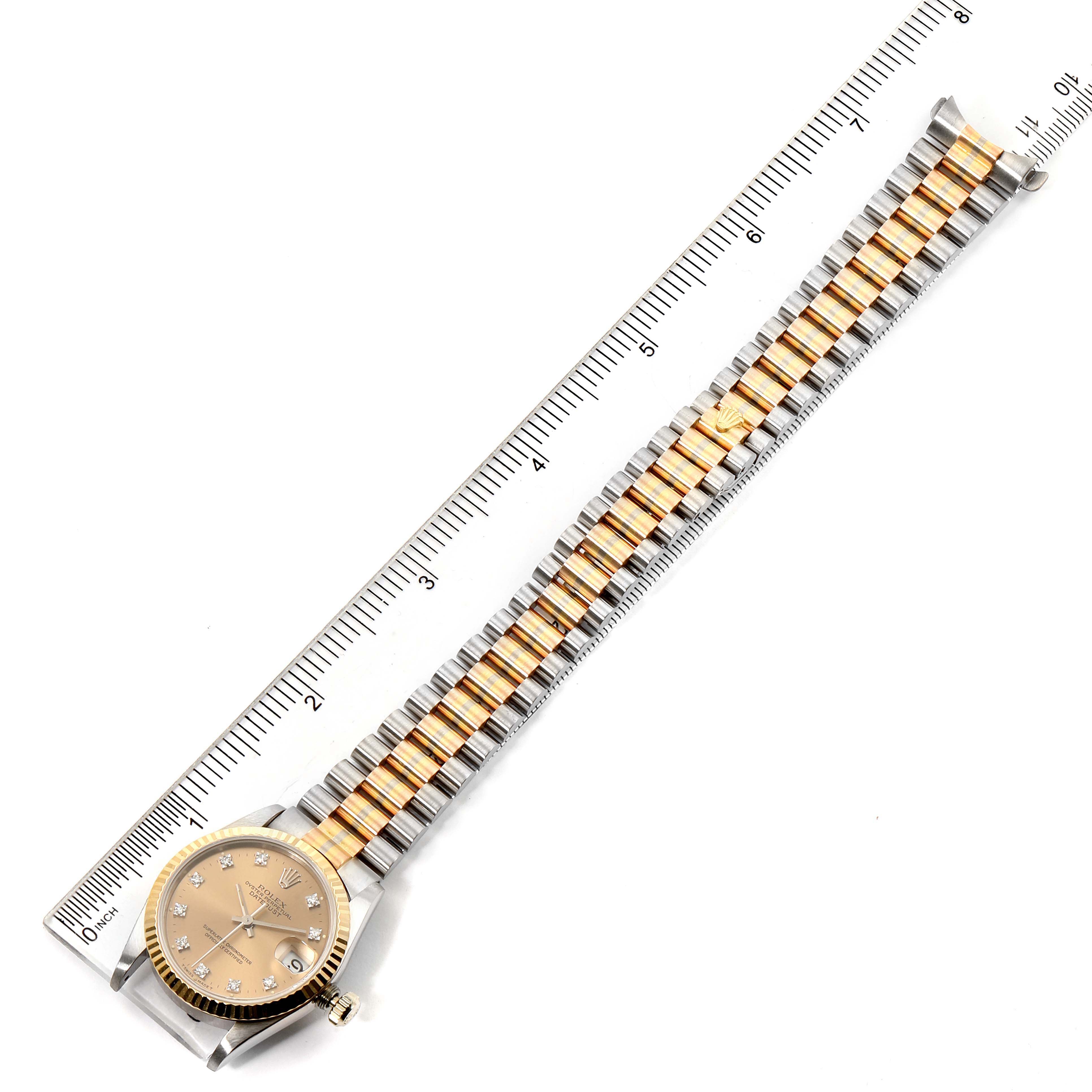 The image shows a Rolex President 68279 Women's Yellow Gold Brown Dial 68279 Women's Yellow Gold Brown Dial model watch laid flat with an extended bracelet alongside a ruler for scale.