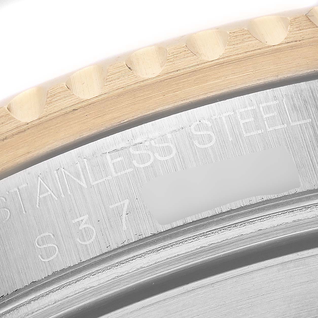 This close-up image shows the edge of the bezel and the engraved stainless steel caseback of a Rolex Submariner 16613 Men
s Steel and Gold (two tone) Blue Dial 16613 Men
s Steel and Gold (two tone) Blue Dial watch.