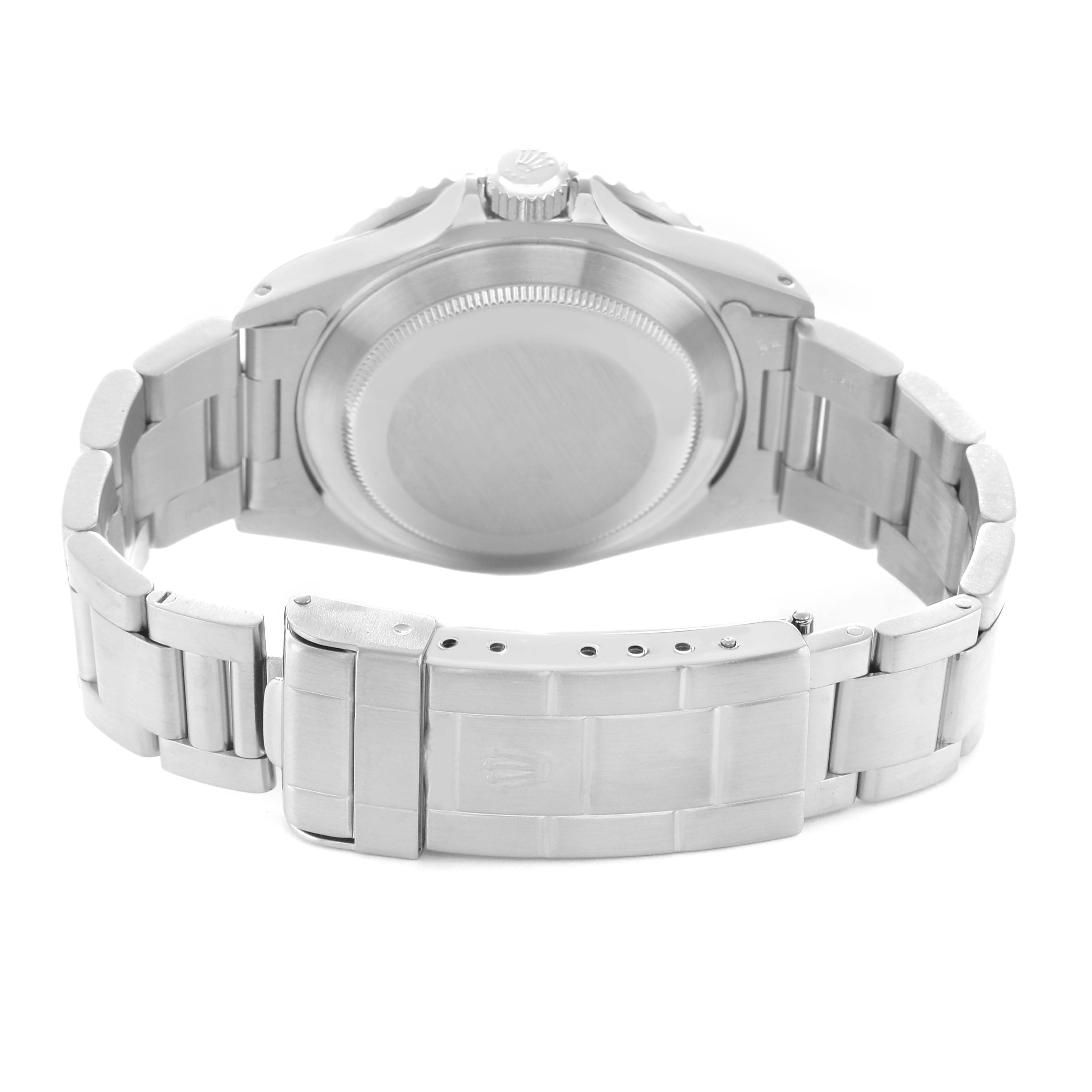 The image shows the back view of a Rolex Submariner 16610 Men's Stainless Steel Black Dial, highlighting the case back and metal bracelet with clasp.