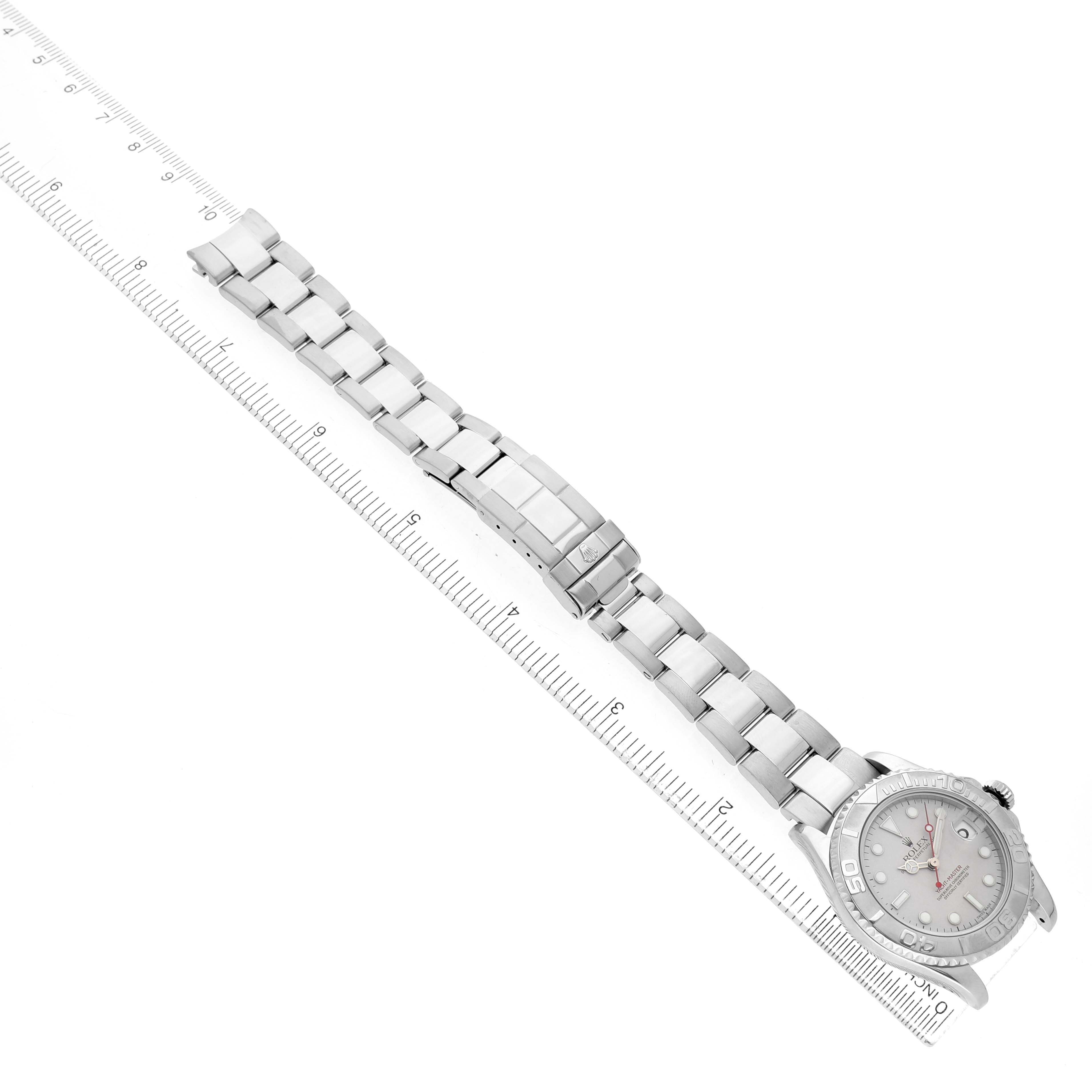 The Rolex Yacht-Master 168622 Men's Stainless Steel Silver Dial watch is shown from an overhead angle, displaying the full bracelet and face alongside a ruler.