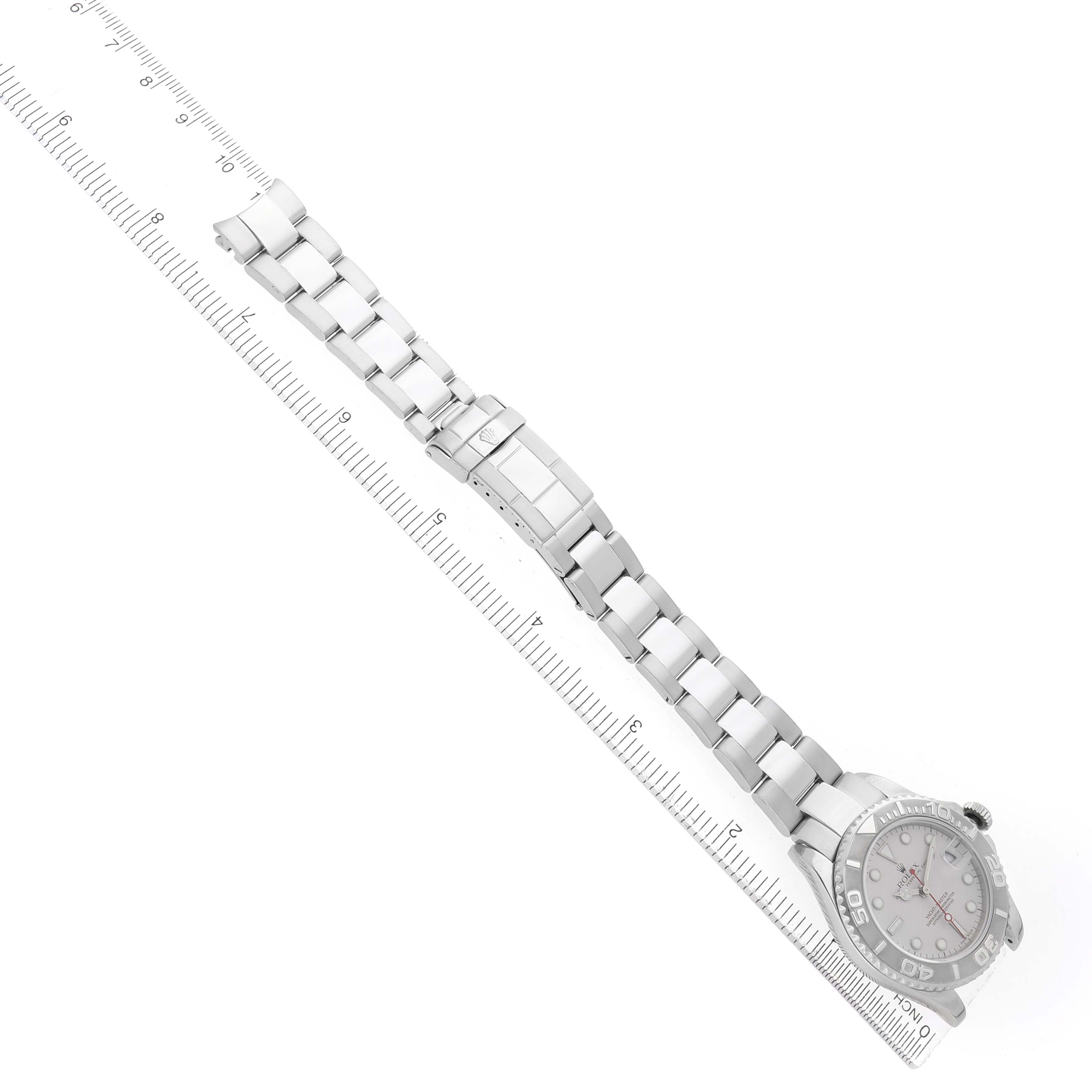 The Rolex Yacht-Master 168622 Men's Stainless Steel Silver Dial watch is shown from an angled top view, displaying the face, bracelet, and clasp aligned with a ruler.