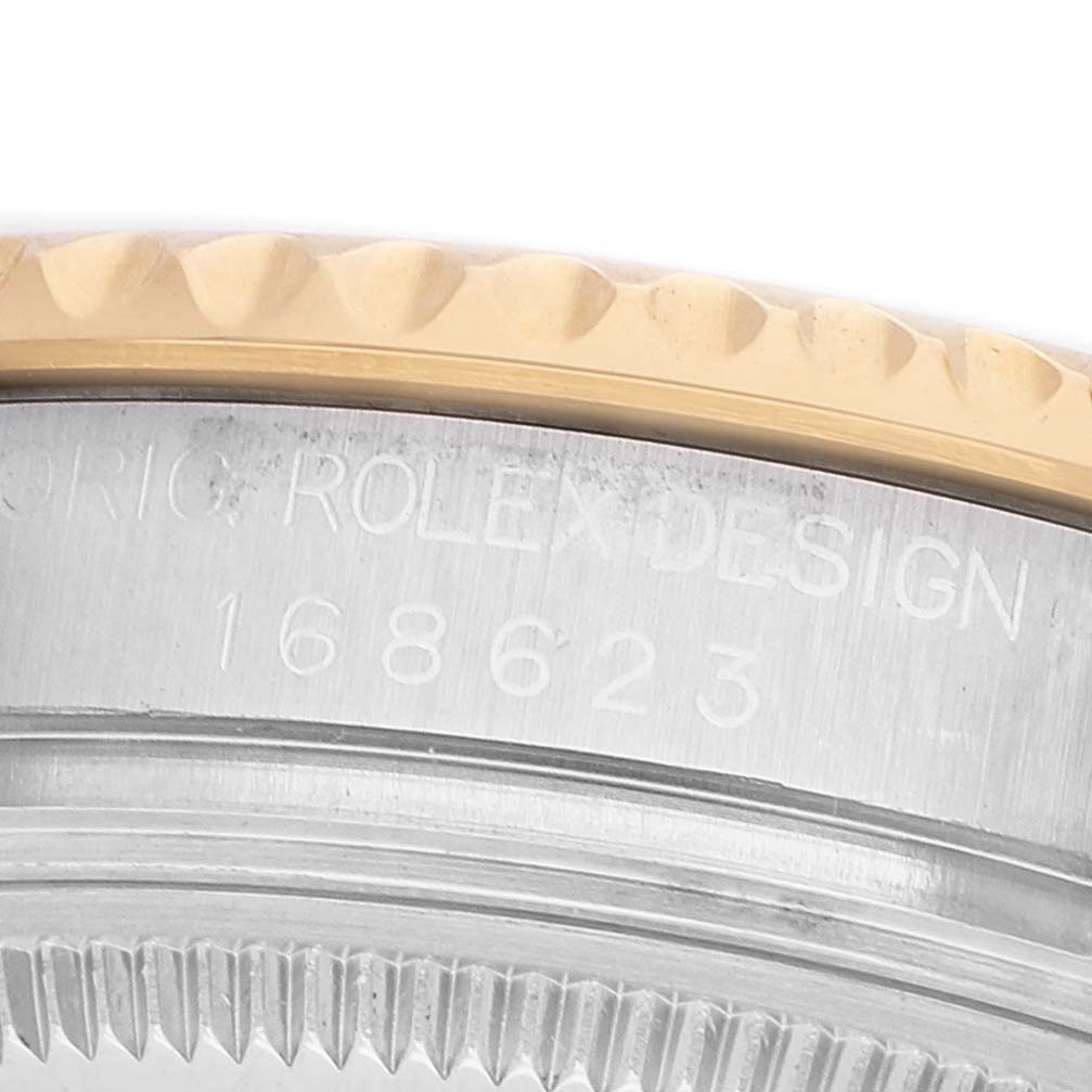 The image shows a close-up of the side of a Rolex Yacht-Master 168623 Men's Steel and Gold (two tone) Silver Dial watch, focusing on the bezel and engraved model number.