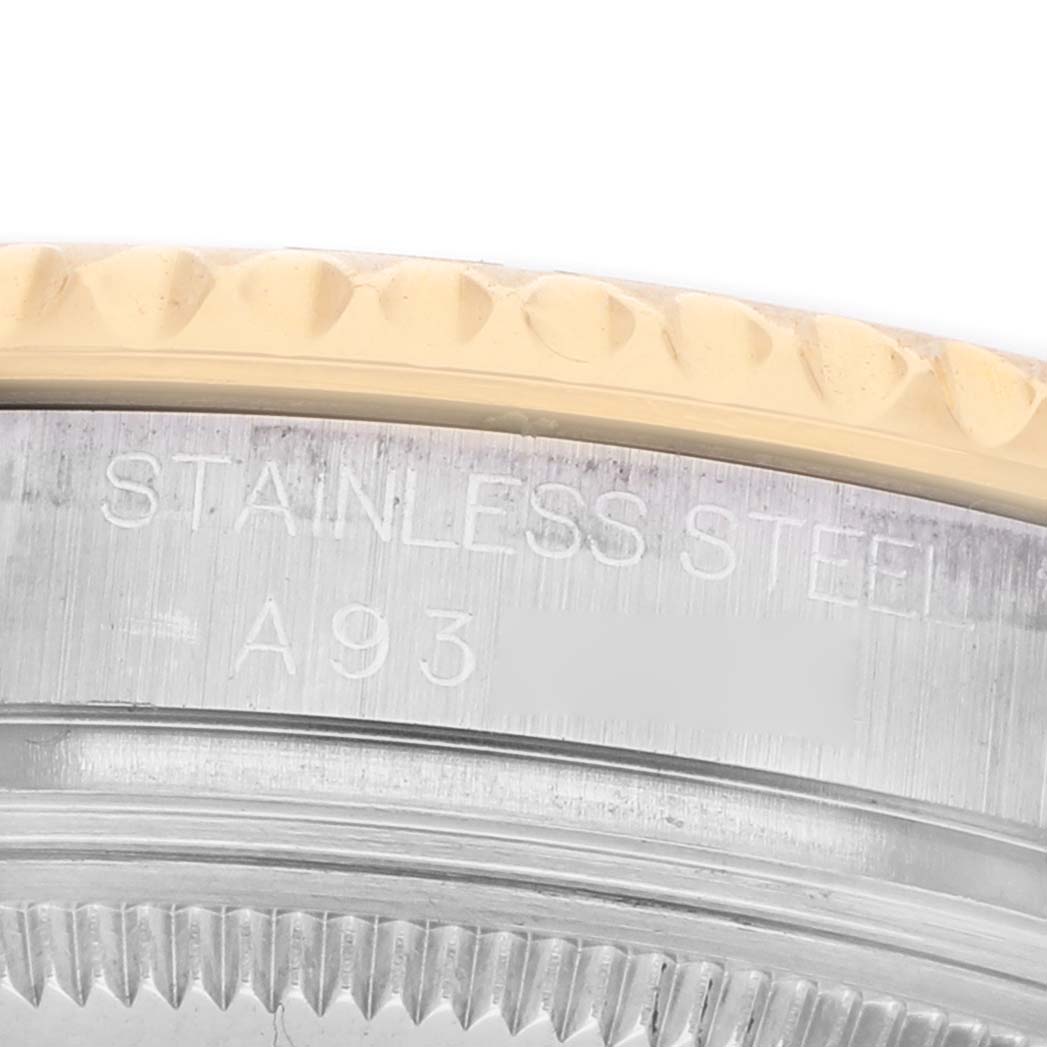 The image shows a close-up of the edge of a Rolex Yacht-Master 168623 Men's Steel and Gold (two tone) Silver Dial's bezel, highlighting the stainless steel and engravings.