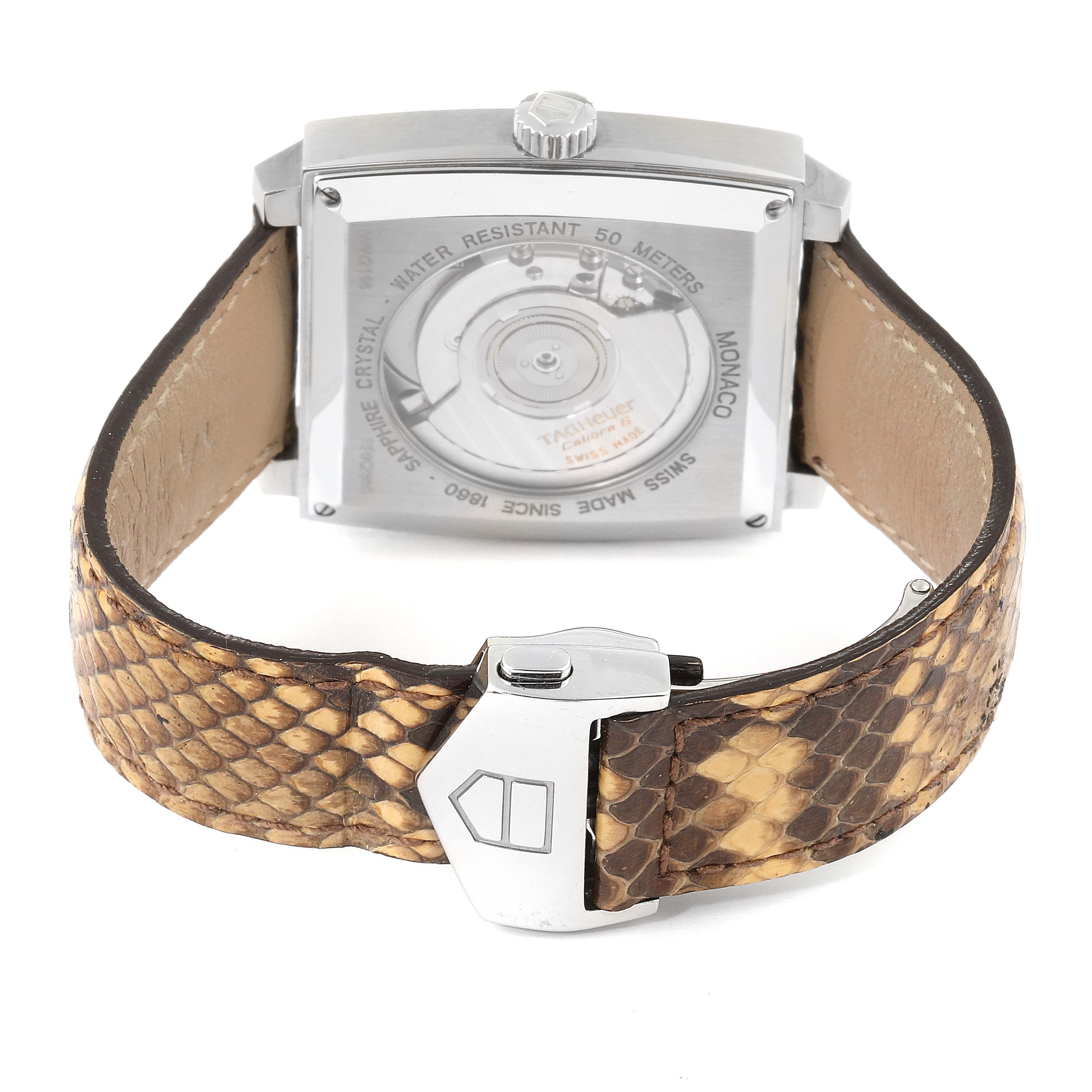 The image shows the back view of a Tag Heuer Monaco WW2116.FC6217 Men's Stainless Steel Brown Dial WW2116.FC6217 Men's Stainless Steel Brown Dial watch, highlighting its movement mechanism and snake-skin patterned strap.