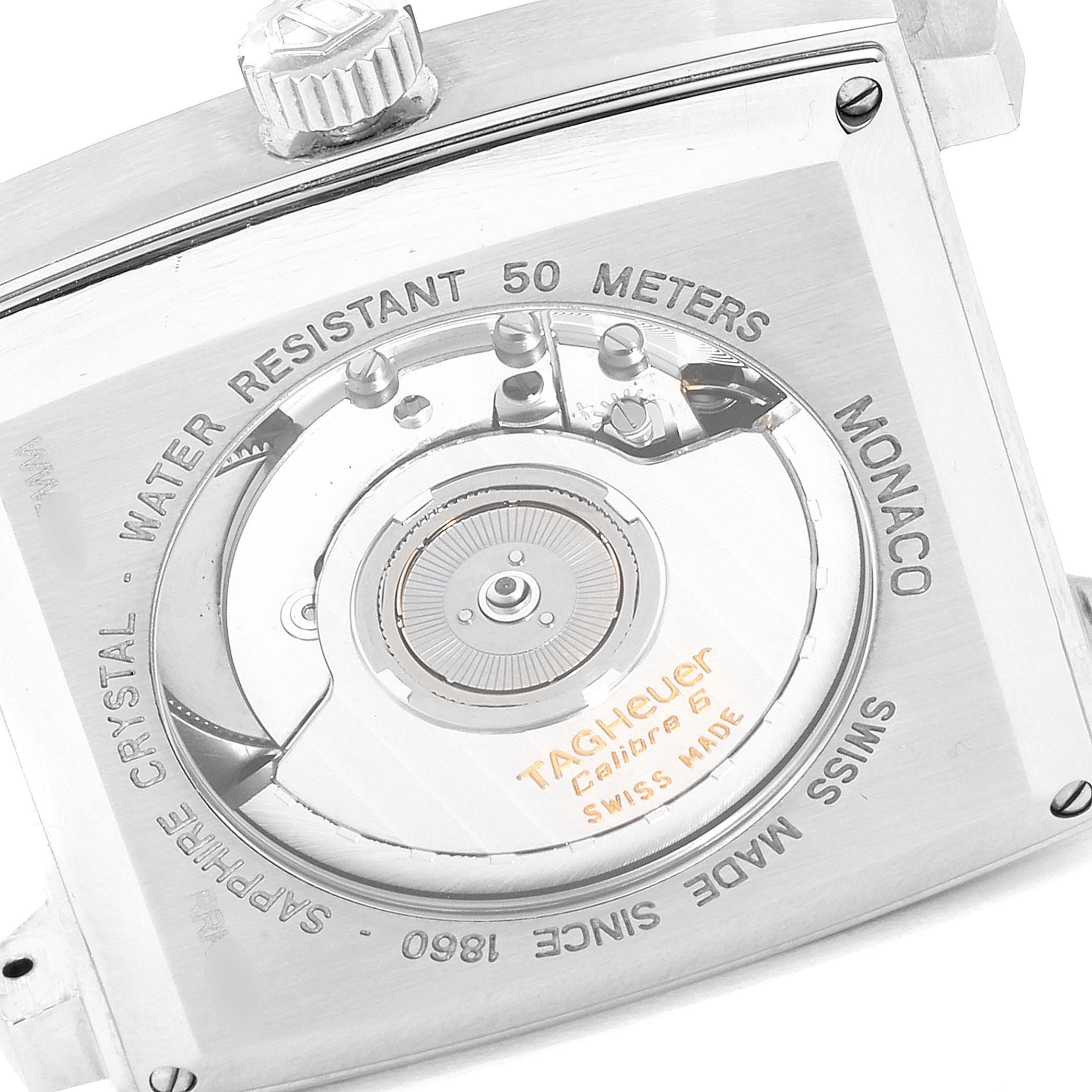 The image shows the back of a Tag Heuer Monaco WW2116.FC6217 Men's Stainless Steel Brown Dial WW2116.FC6217 Men's Stainless Steel Brown Dial watch, highlighting its internal mechanism and inscriptions.