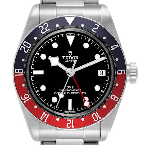 The Tudor Heritage Black Bay watch is shown from a front angle, displaying its bezel, dial, hands, and crown.