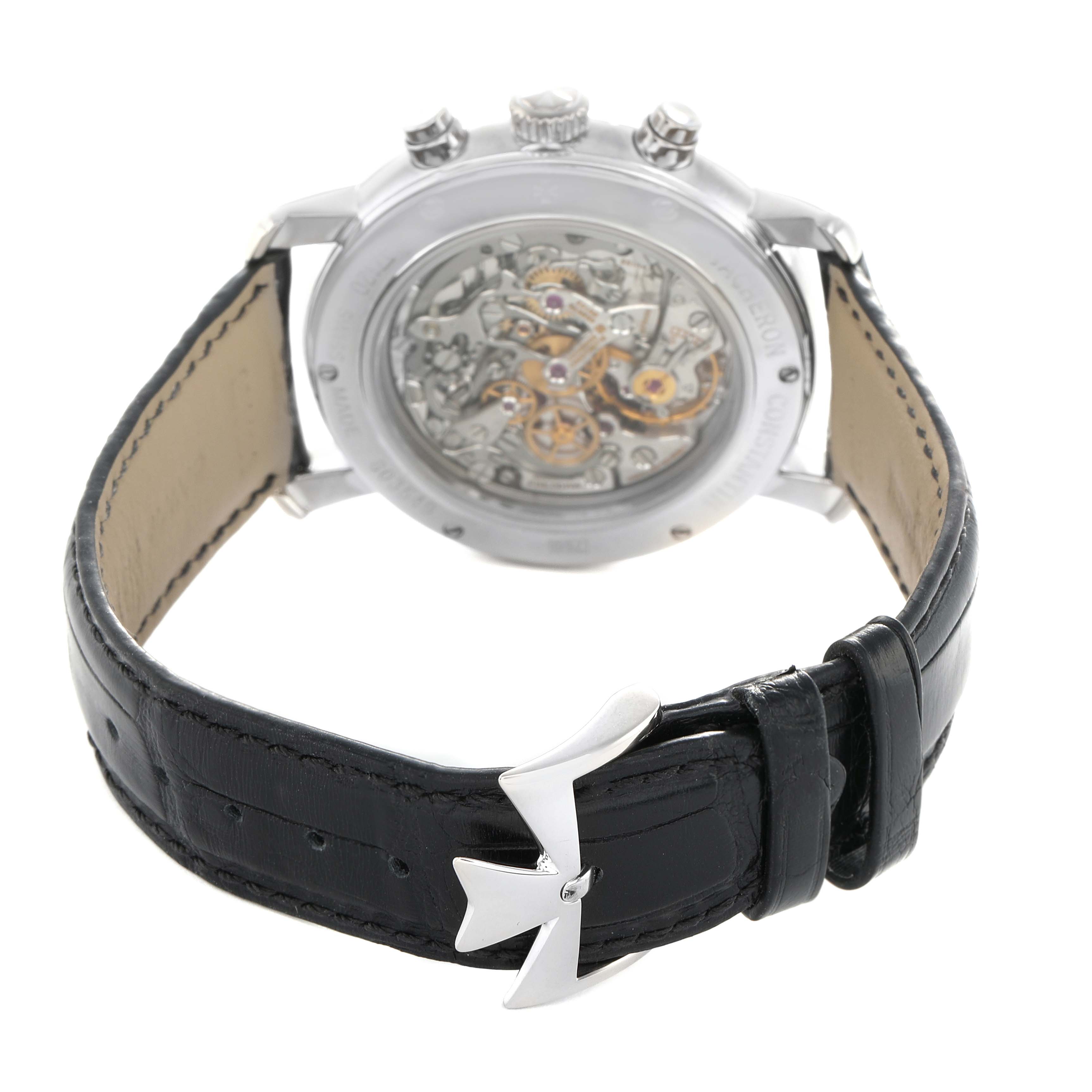 The image shows a Vacheron Constantin Malte 47120 Men's White Gold Silver Dial watch from the back, highlighting the movement and leather strap with a distinctive clasp.