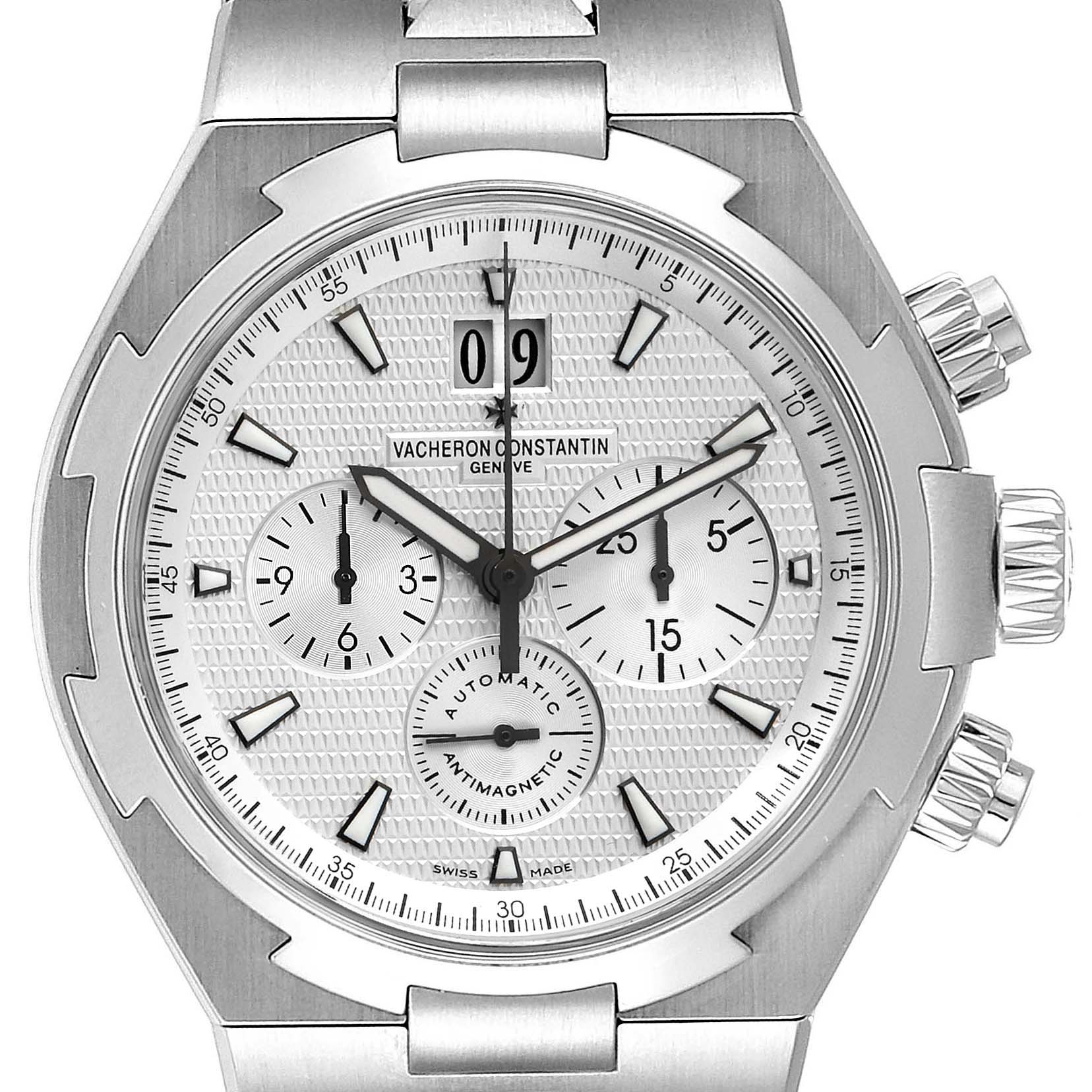 The image displays a frontal view of a Vacheron Constantin Overseas 49150 Men's Stainless Steel Silver Dial 49150 Men's Stainless Steel Silver Dial watch, showcasing its dial, hands, and two pushers on the right side.