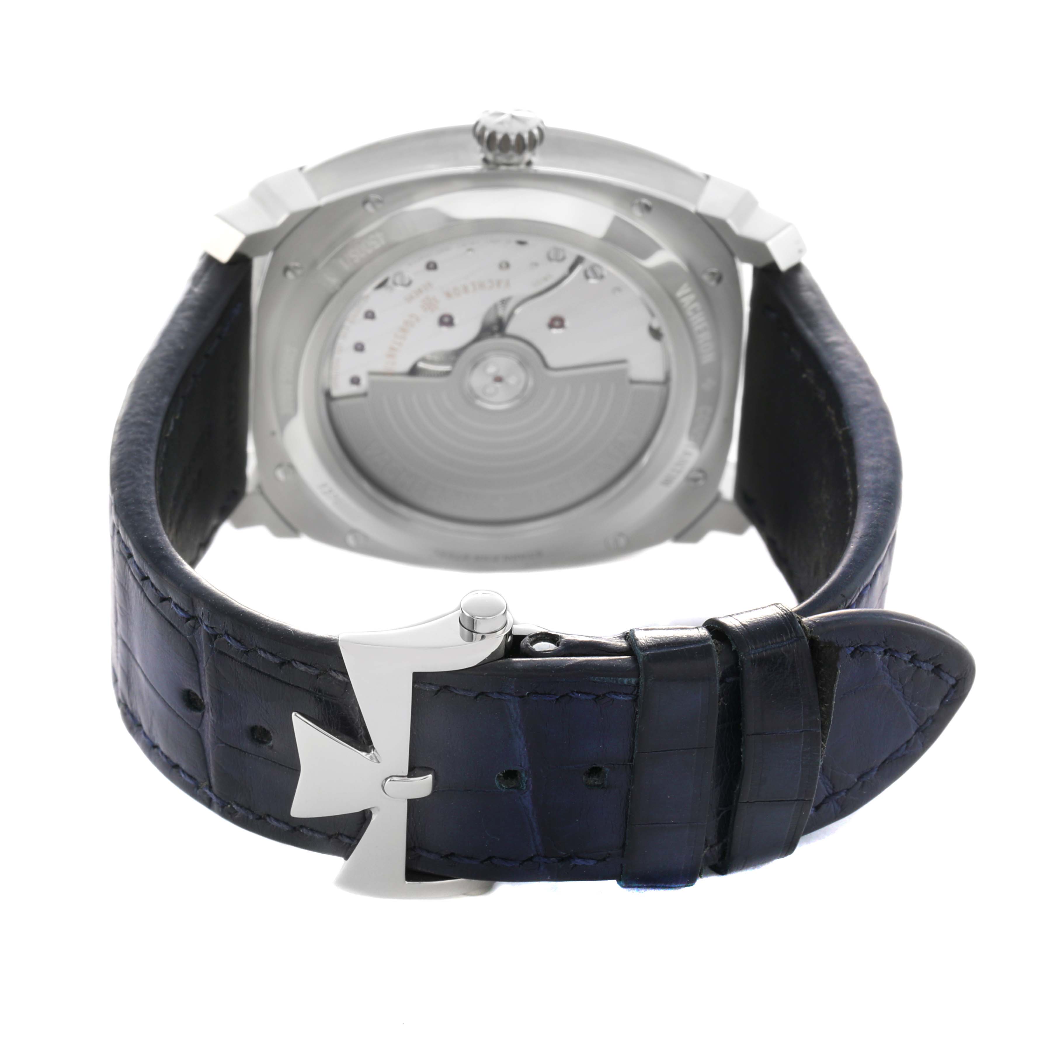 The Vacheron Constantin Quai de l'Ile watch is shown from the rear, displaying the back casing, movement, and strap buckle.