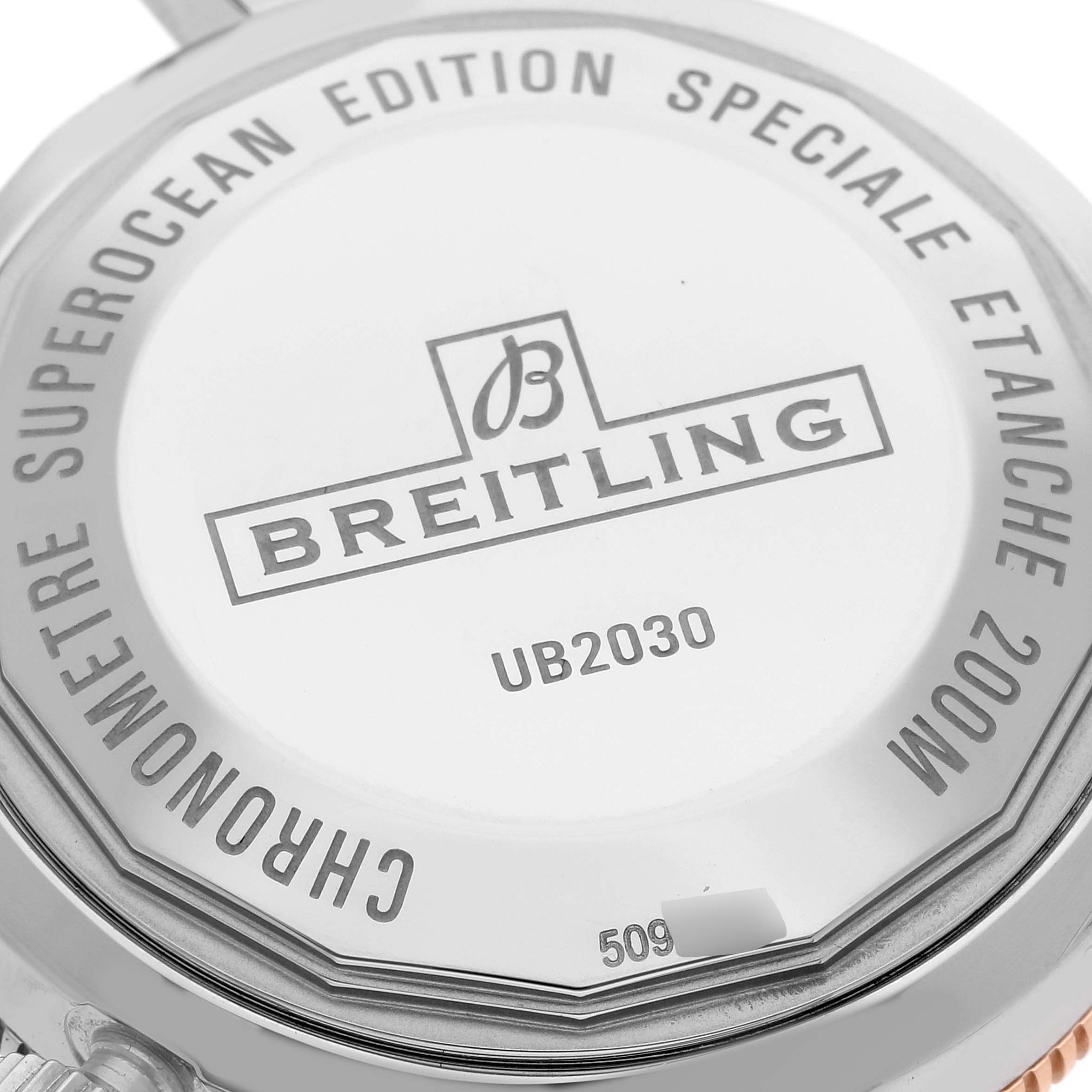 This image shows the back case of a Breitling Superocean UB2030121B1S1 Men's Steel and Gold (two tone) Black Dial UB2030121B1S1 Men's Steel and Gold (two tone) Black Dial model watch, displaying the logo, model number, and specifications.