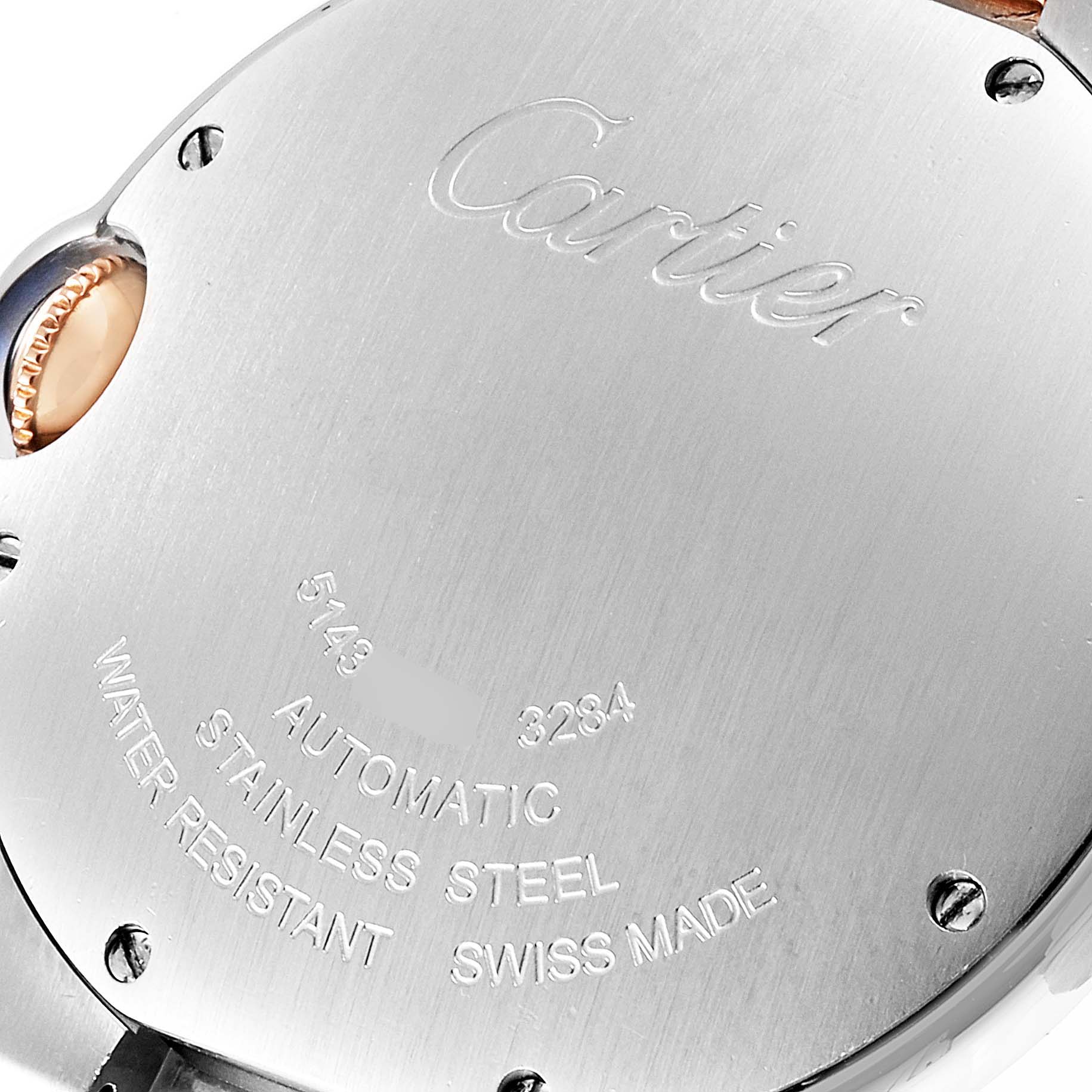 The image shows the back view of the Cartier Ballon Bleu WE902031 Women
s Steel and Gold (two tone) Silver Dial WE902031 Women
s Steel and Gold (two tone) Silver Dial watch with visible engravings and crown.