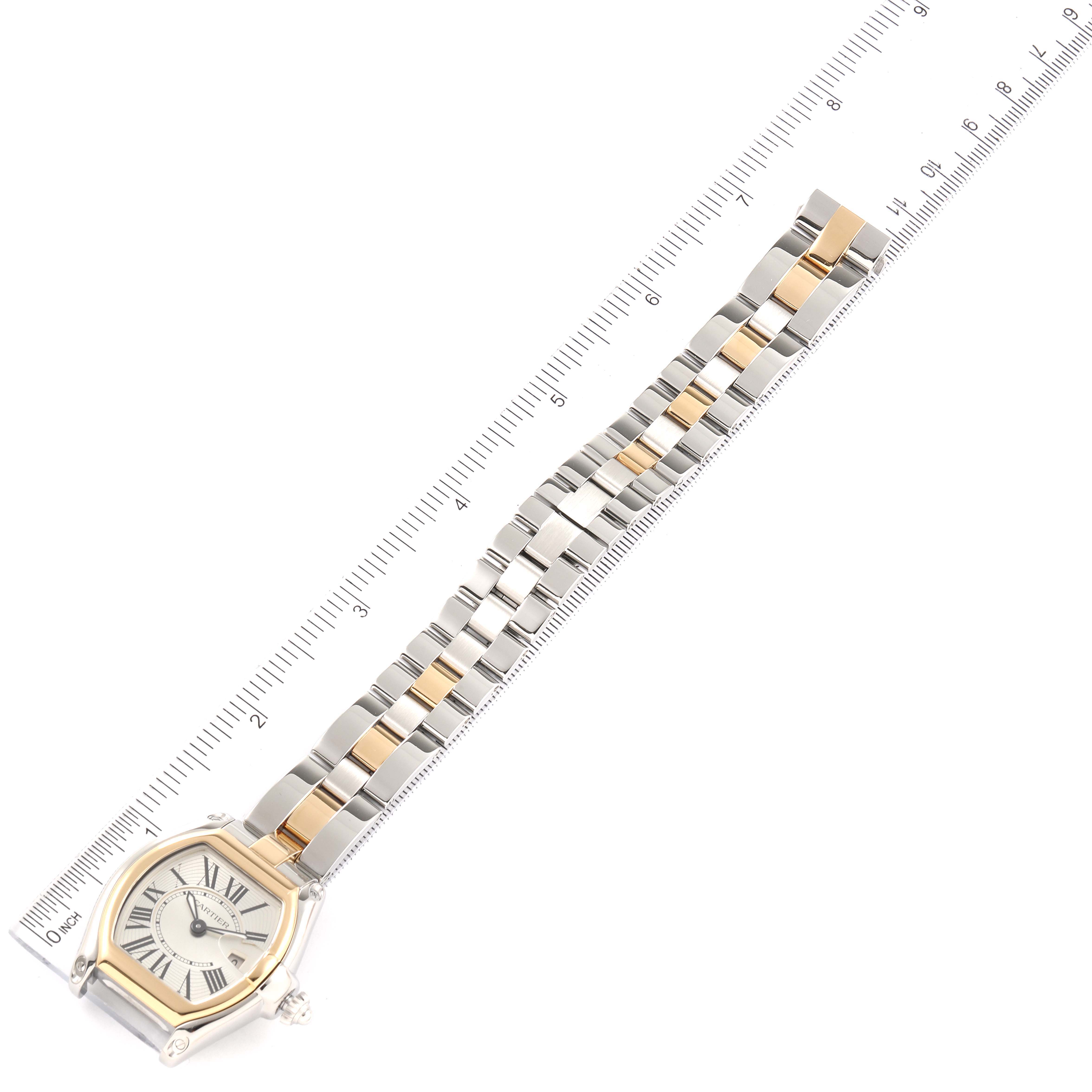 The image shows a top-down view of a Cartier Roadster W62026Y4 Women
s Steel and Gold (two tone) Silver Dial W62026Y4 Women
s Steel and Gold (two tone) Silver Dial watch, including the face and the full length of the metal bracelet with a ruler alongside.