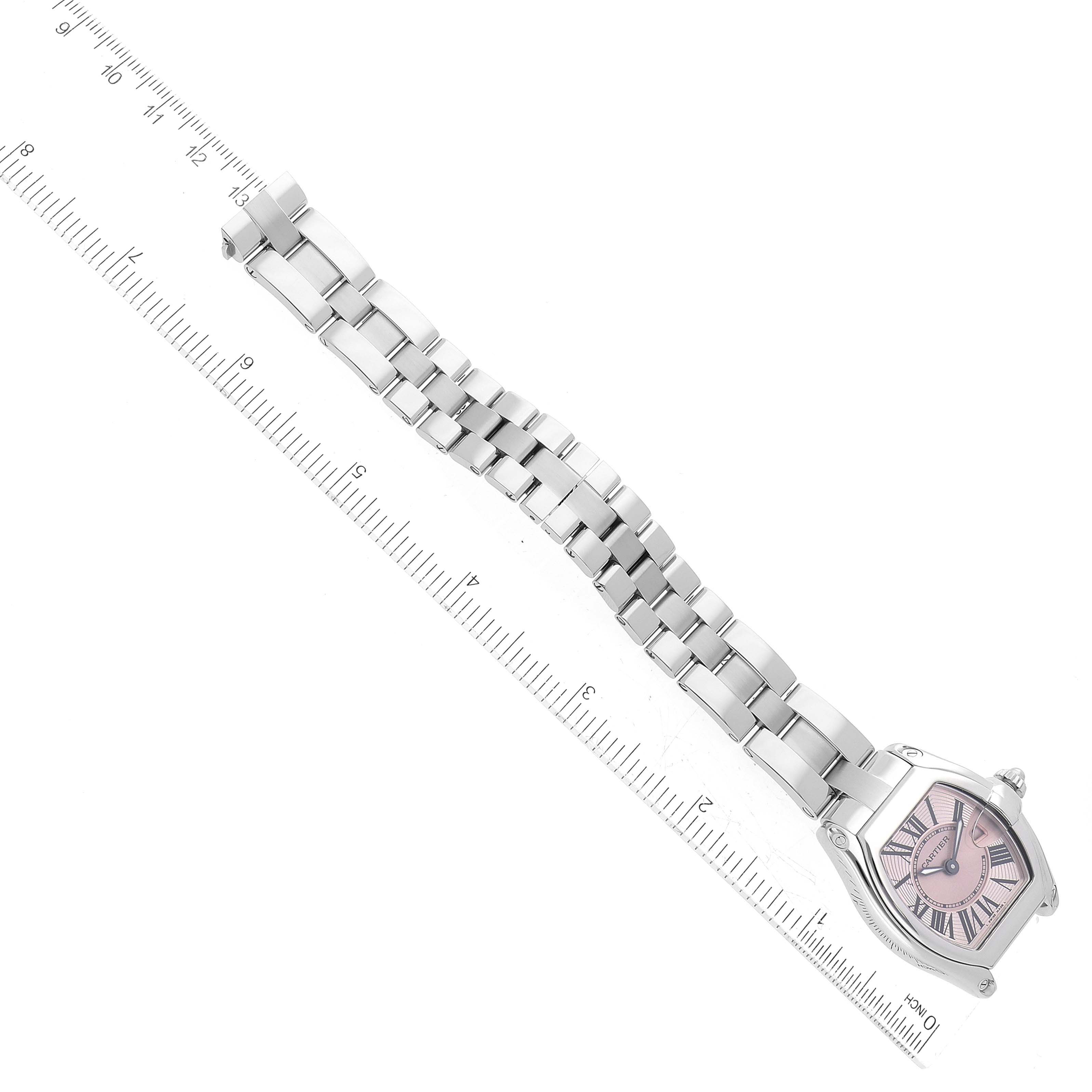 The image shows the entire face and bracelet of the Cartier Roadster W62017V3 Women's Stainless Steel Pink Dial W62017V3 Women's Stainless Steel Pink Dial watch, laid out alongside a ruler.