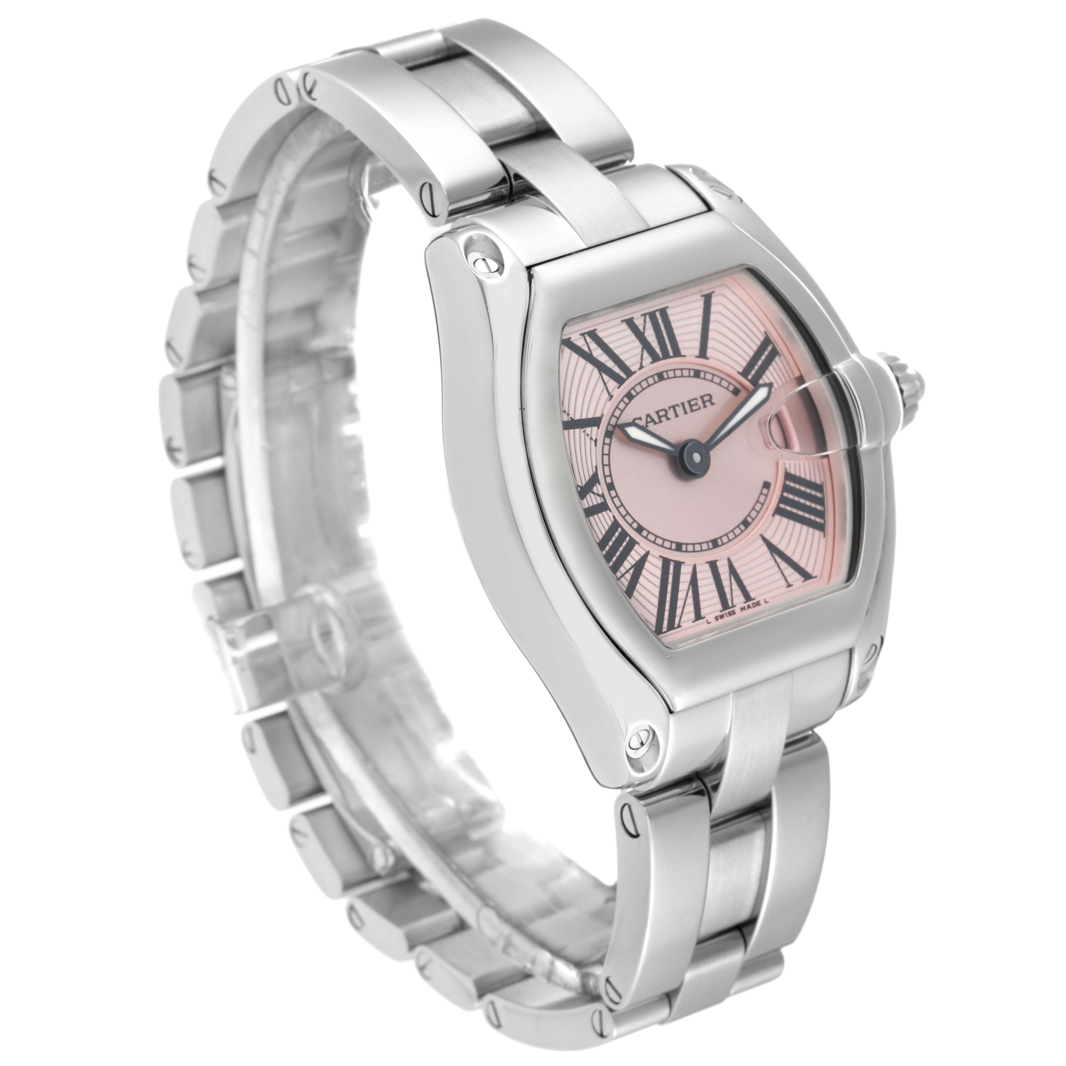 The image shows a Cartier Roadster W62017V3 Women's Stainless Steel Pink Dial W62017V3 Women's Stainless Steel Pink Dial watch from a front-left angle, displaying its bracelet, case, and pink dial.