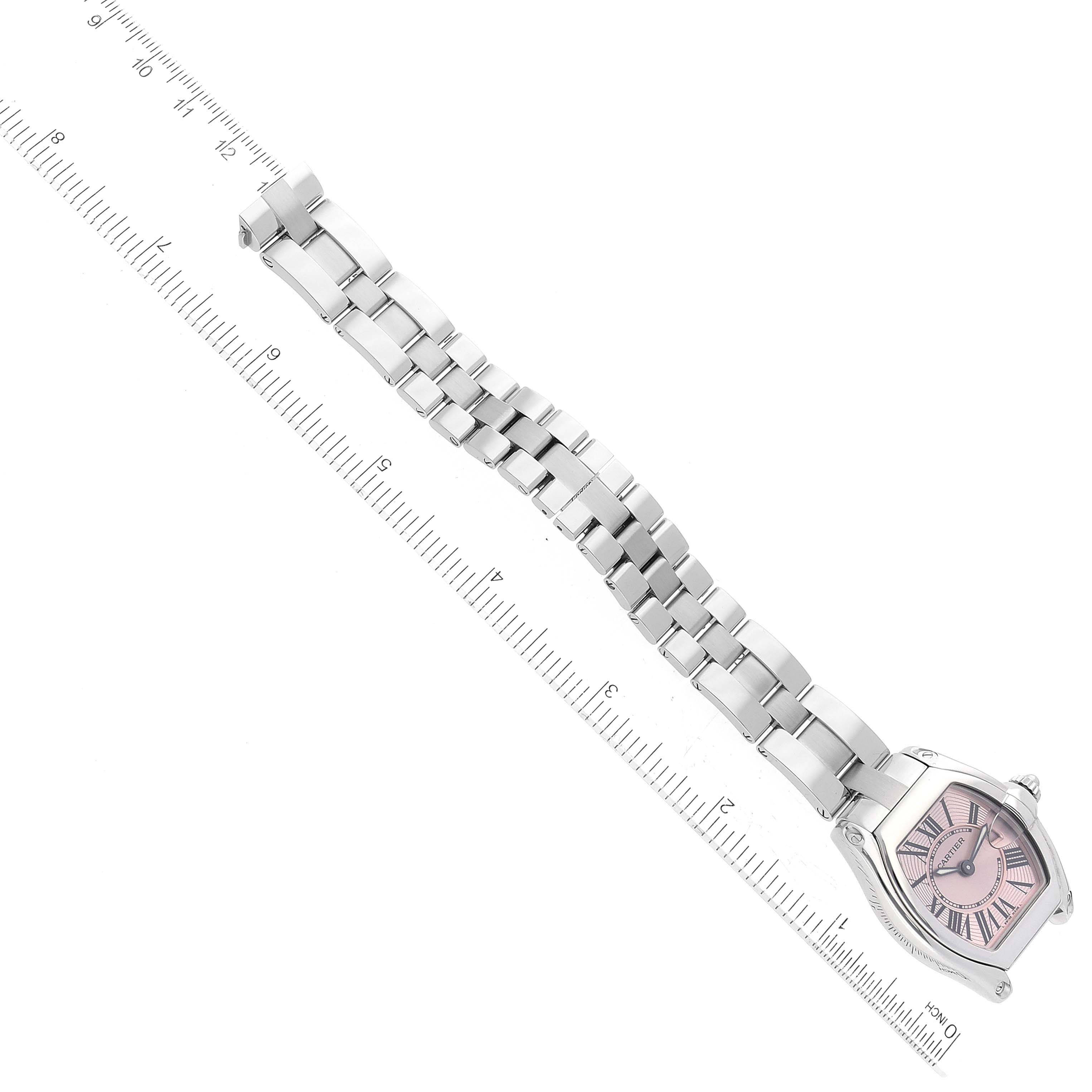 The Cartier Roadster W62017V3 Women's Stainless Steel Pink Dial W62017V3 Women's Stainless Steel Pink Dial watch is displayed flat with its face and full metal bracelet alongside a measuring ruler.