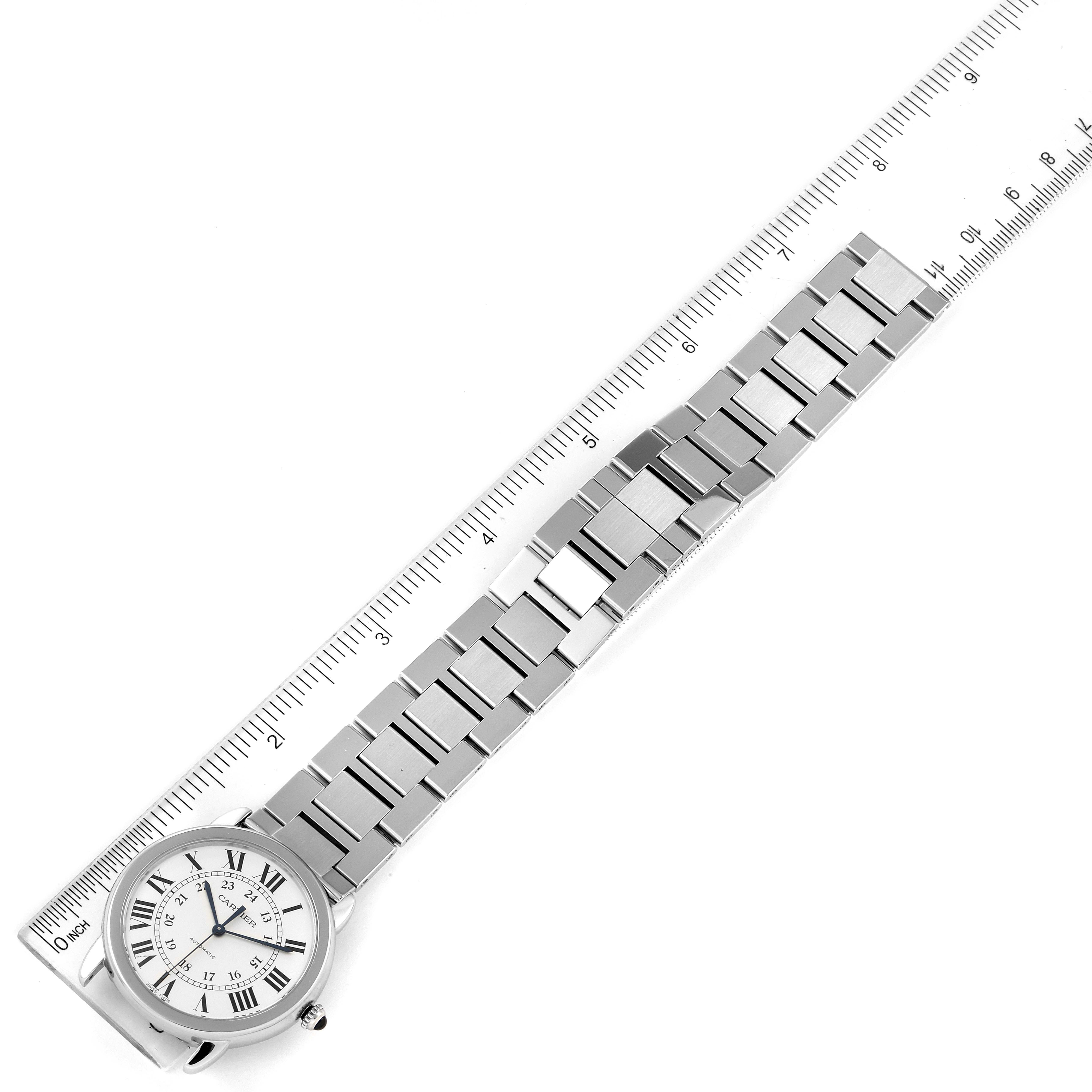 The image shows the face and stainless steel band of a Cartier Ronde WSRN0012 Women's Stainless Steel Silver Dial WSRN0012 Women's Stainless Steel Silver Dial watch, angled diagonally next to a ruler.