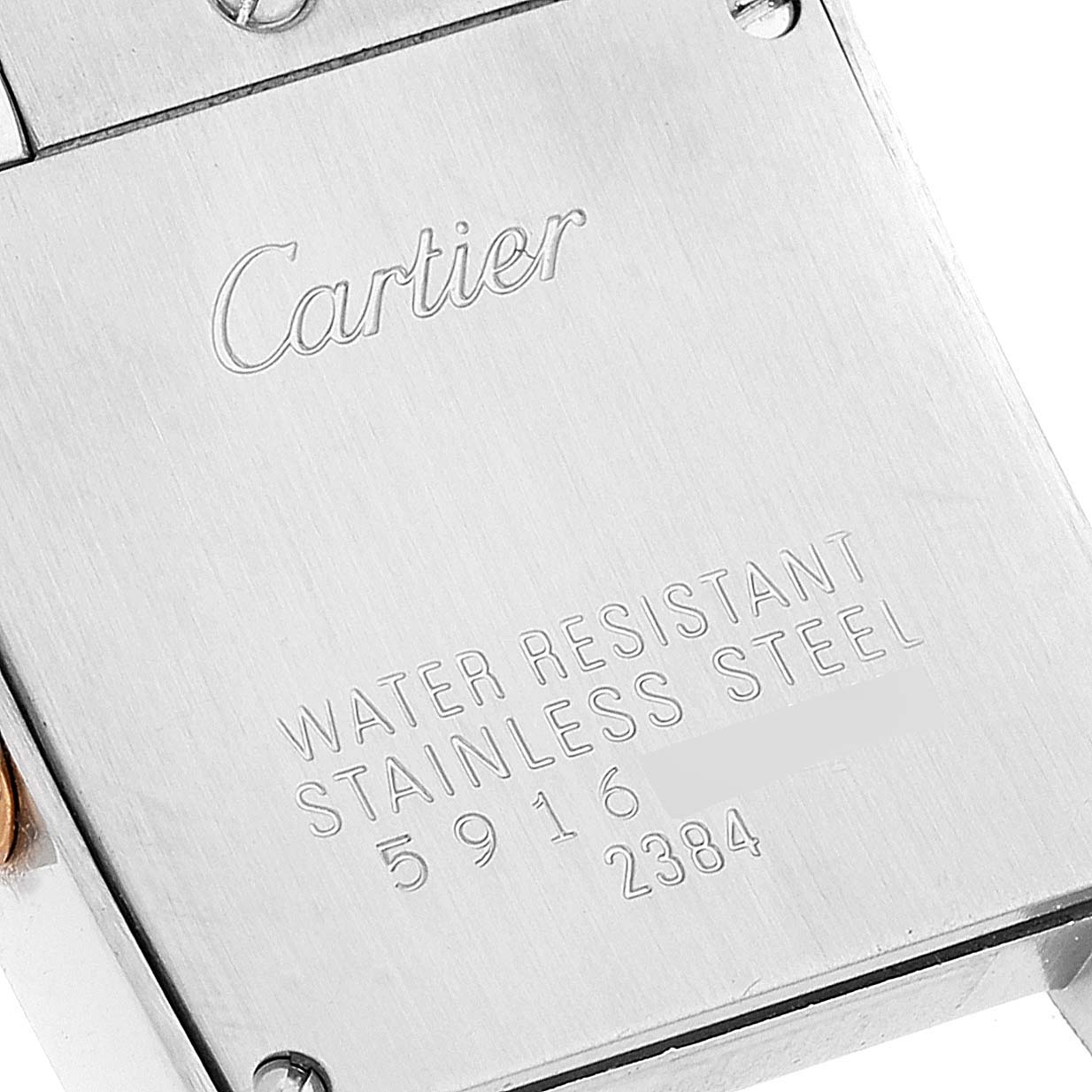 The image shows the case back of a Cartier Tank Francaise W51027Q4 Women's Steel and Gold (two tone) Mother of Pearl Dial W51027Q4 Women's Steel and Gold (two tone) Mother of Pearl Dial watch, featuring engraved details including the brand name and specifications.